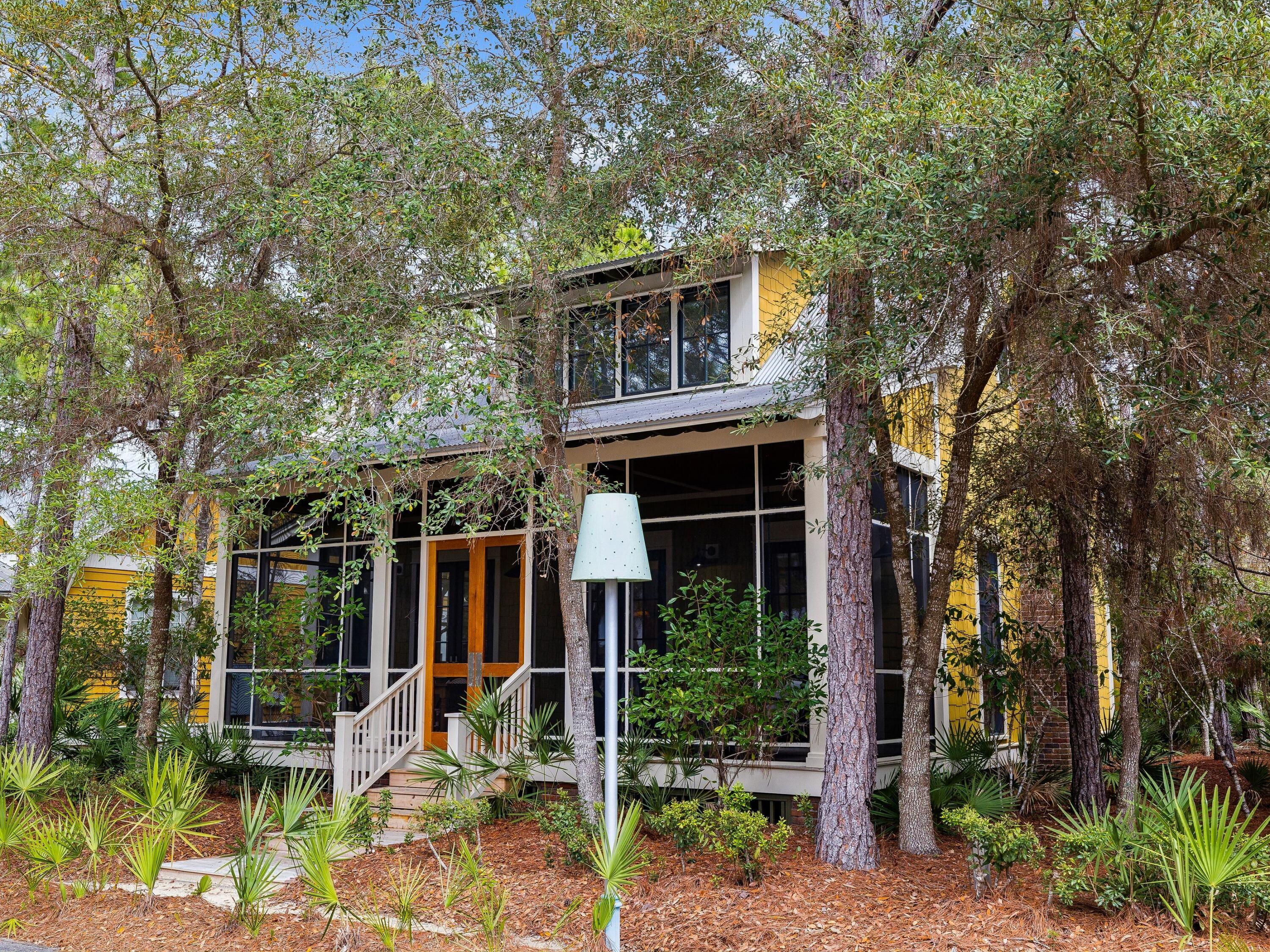Positioned within the highly sought-after Phase II of WaterColor, this thoughtfully designed cottage offers the rare balance of privacy and proximity to the area's most celebrated amenities.Set along a charming pocket park where neighbors gather for bocce ball, lawn games and relaxed afternoon picnics, the home enjoys a peaceful setting that still places you moments from the beach and vibrant energy of Scenic Highway 30A.
Inside, 10-foot ceilings and rich hardwood floors create a light, inviting atmosphere. The main living area is anchored by a striking all-brick fireplace that adds warmth and architectural character while creating a natural gathering place for family and friends after a day along the coast.

The kitchen is designed to....... ........satisfy both everyday living and entertaining with equal ease. Granite countertops pair with a re-tiled backsplash and stainless steel appliances, while a Viking Professional range elevates the culinary experience. A generous breakfast bar island with an integrated sink seamlessly connects the kitchen to the living area, creating a welcoming space for casual meals, conversation and evening gatherings.

Thoughtful upgrades continue throughout the home. A Rinnai endless hot water system ensures comfort and efficiency, while upgraded media wiring supports modern connectivity for work or relaxation. Just off the side entrance, a well-appointed utility room adds another layer of convenience with custom cabinetry and drawers, washer and dryer, a Uline mini-fridge and a dedicated sink--an ideal space for organization after beach days or pool afternoons.

Outdoor living is equally effortless. Just steps away, the outdoor shower provides the perfect place to rinse off after returning from the pool or the white sand beaches along the nearby gulf.

Life here extends well beyond the front door. Residents of WaterColor enjoy access to an exceptional collection of amenities, including 10 community pools, the renowned Beach Club with three pools and three dining venues, and Camp WaterColor featuring multiple pools and a winding lazy river. More than 35 miles of scenic walking and biking trails weave through the community, while pickleball courts, a tennis center with Har-Tru courts and paddleboard access on Western Lake provide endless ways to enjoy the coastal lifestyle.

Classic craftsmanship, thoughtful details and an enviable setting along 30A make this cottage a timeless retreat designed for both quiet moments and memorable gatherings.