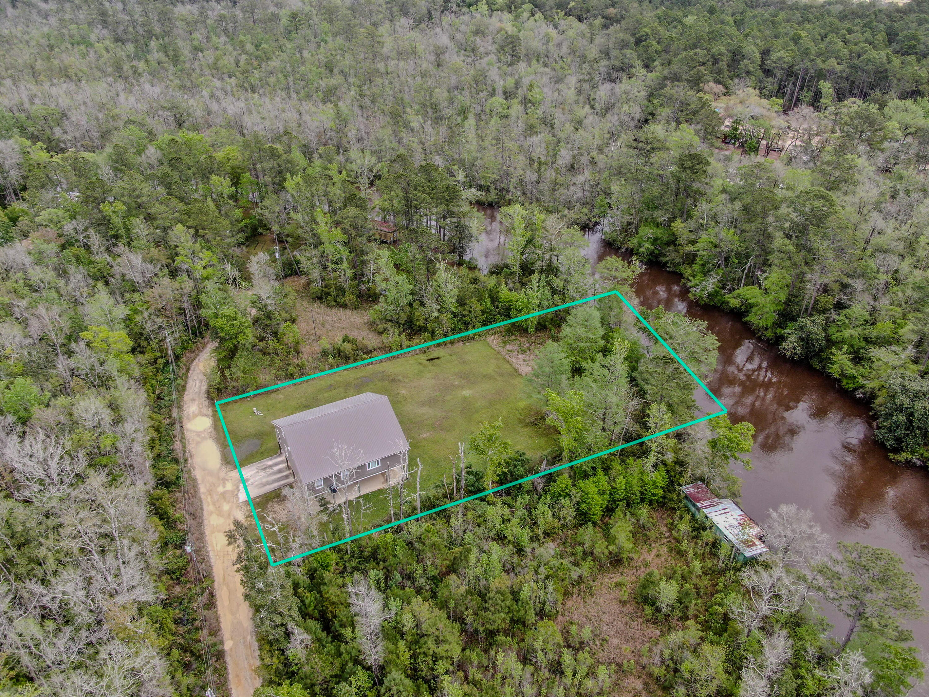 Discover your private waterfront sanctuary on serene Alaqua Creek in beautiful Freeport, Florida. This exceptional elevated home at 264 Johns Lane blends modern comfort with generous outdoor space on a spacious private lot with direct creek access and mature trees--perfect for privacy and Florida Panhandle living.
The thoughtfully updated interior offers approximately 2,918 square feet. The open main floor features a stunning kitchen with white shaker cabinetry, granite countertops, and a distinctive statement range. A spacious living area with cozy fireplace flows to expansive porches and a large screened patio overlooking peaceful woods and creek views.
Upstairs, a massive vaulted bonus room provides incredible versatility for a home gym, playroom, media lounge, or guest quarters. Four comfortable bedrooms and two well-appointed bathrooms include a fun-themed children's room and charming nursery.
Outside, enjoy a large cleared grassy area ideal for recreation and outdoor activities, plus direct Alaqua Creek access perfect for fishing and kayaking. The open lower level of the home provides covered parking and storage space, while mature trees ensure privacy and a tranquil setting.
Conveniently located on a private road yet near pristine beaches, shopping, dining, and excellent schools in growing Walton County, this move-in-ready waterfront retreat delivers peaceful seclusion with easy Emerald Coast access. Schedule your private tour today!