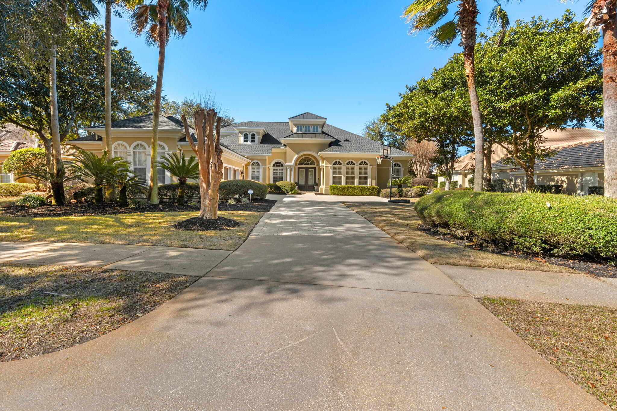 NEW PRICE IMPROVEMENT! Stunning custom home in Kelly Plantation! This spacious 5-bedroom residence, with first floor master suite, dedicated office and huge media room, offers 4,119 sq ft of beautifully designed open living space and is positioned directly on the 17th-hole tee box of the renowned Kelly Plantation Golf Course. Featuring 12-foot ceilings, abundant natural light, and plantation shutters throughout, the home feels open, refined, and welcoming. The gourmet kitchen and expansive living areas seamlessly flow for easy entertaining, while upgraded hardwood floors in the bedrooms add warmth and elegance.
New roof in 2024. New resurfaced pool and pump. Outdoors, enjoy poolside views of the course and a serene setting perfect for relaxing or entertaining.  NO FLOOD INSURANCE REQUIRED. New built in refrigerator, and freshly painted inside and out!