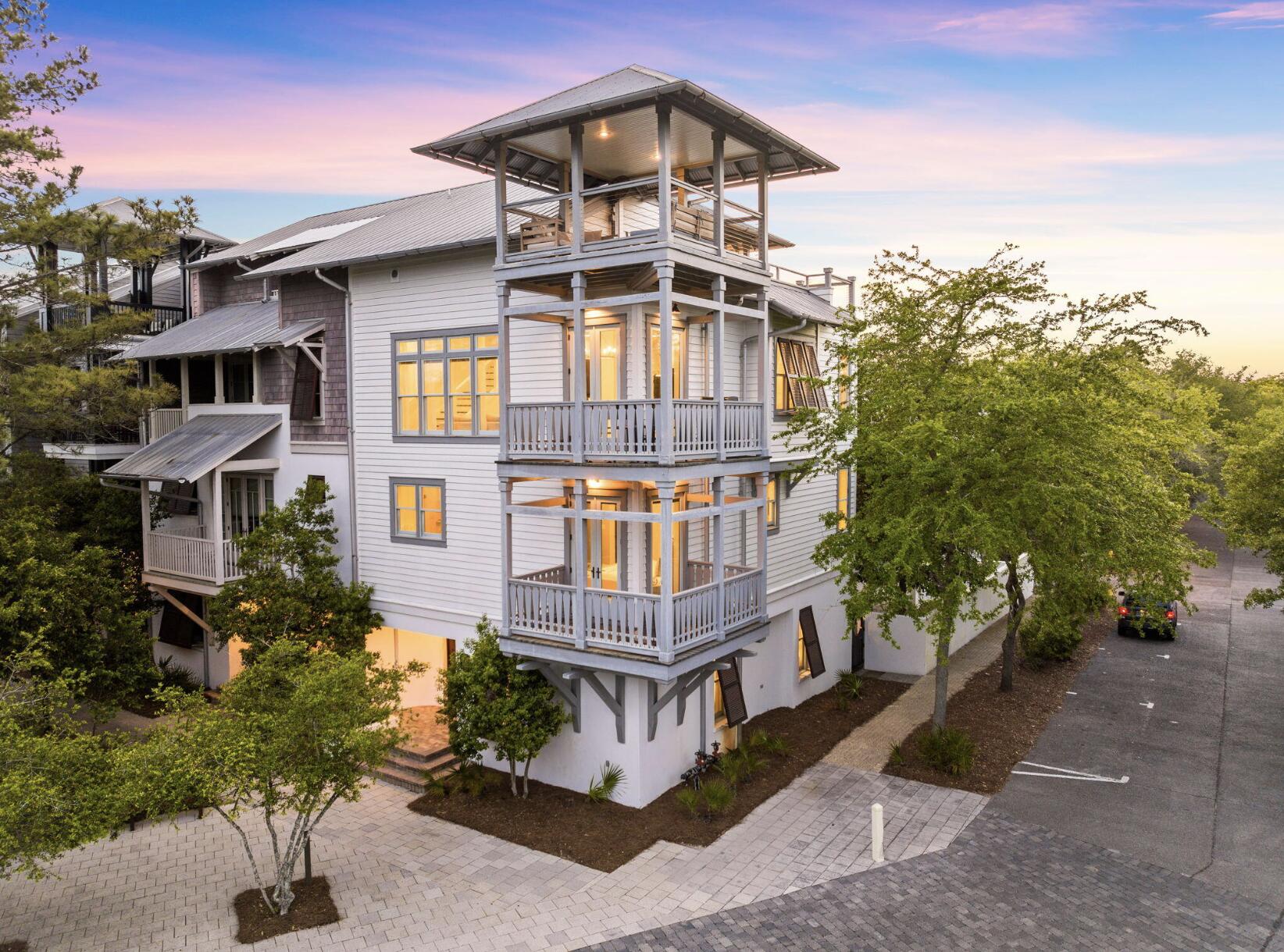 Welcome to 5 Johnstown Lane, an exquisite four-story home situated in the heart of Rosemary Beach that is the BEST PRICED HOME PER SQUARE FOOT on the market in Rosemary Beach! And to top it off, the highly-motivated seller is offering a $50,000 CONCESSION towards upgrades and improvements! Overlooking the St. Augustine Green in Rosemary Beach, this fully-furnished, elevator-equipped, four-story home is a must-see! Enjoy the panoramic views of the lush greenery and Rosemary Beach from every level, featuring balconies on the second, third, and fourth floors. One of our favorite features of this home is the wrap-around rooftop balcony. This is one of only 13 homes in Rosemary Beach with a tower designation, so the view over the hundreds of other homes is incredible! The allure continues with APPROVAL from the town architect for a PRIVATE POOL or CARRIAGE HOUSE to enhance the outdoor experience if desired.

With its reverse floor plan and wrap-around balconies, the only tough choice you'll make once you arrive is which views to enjoy and where.  This beautiful residence is light and bright, decorated in neutral colors and illuminated by natural light flooding in through the many windows. The rustic modern fixtures throughout complement the gorgeous dark wood floors beautifully. 

This lovely 4-story home is equipped with a private elevator and accommodates up to 15 people with 5 bedrooms, 4.5 baths, plus an additional bunk room; great for multiple families with over 3,500 sq ft of space. There are two guest suites and a wet bar on the first floor, each room complete with a king bed, private bath with custom tile shower, and a large closet. 

Another guest suite, as well as the master suite, can be found on the 2nd floor, each with a king bed, private bath, and walk-in closet. The master suite features a private balcony, a wet bar, double vanities, a large soaking tub with treetop views, and a custom tile shower. 

Continuing upward, the kitchen, living, dining and powder room are located on the 3rd floor with an open concept and an abundance of light. The kitchen is full of upgrades, including granite counter tops, a wine cooler, stainless steel decor, Kitchen Aid appliances, and a custom backsplash. There is another wrap-around balcony overlooking St. Augustine Green off the living room where the grill is located conveniently close to the kitchen. 

The fourth floor completes this residence with additional living space, a bunk room with three twin beds, and a wrap-around roof top balcony, where you can relax and enjoy sunset views and concerts in St. Augustine Park.

This home not only captures stunning views of the St. Augustine Green from every level, but is also in a great location. There is a water park with a splash pad for the kids and adults to cool off just beyond the front door. Not to mention the dining and shopping of Rosemary Beach's town square is a short 3 minute walk or quick bike ride away. Enjoy the exclusive amenities of Rosemary Beach, including four community pools, an owner's-only club just steps away from 5 Johnstown Lane, tennis courts, expansive green spaces, a gym, fitness trails, and much more. 

Come discover a world of luxury, comfort, and relaxation in this Rosemary Beach retreat!