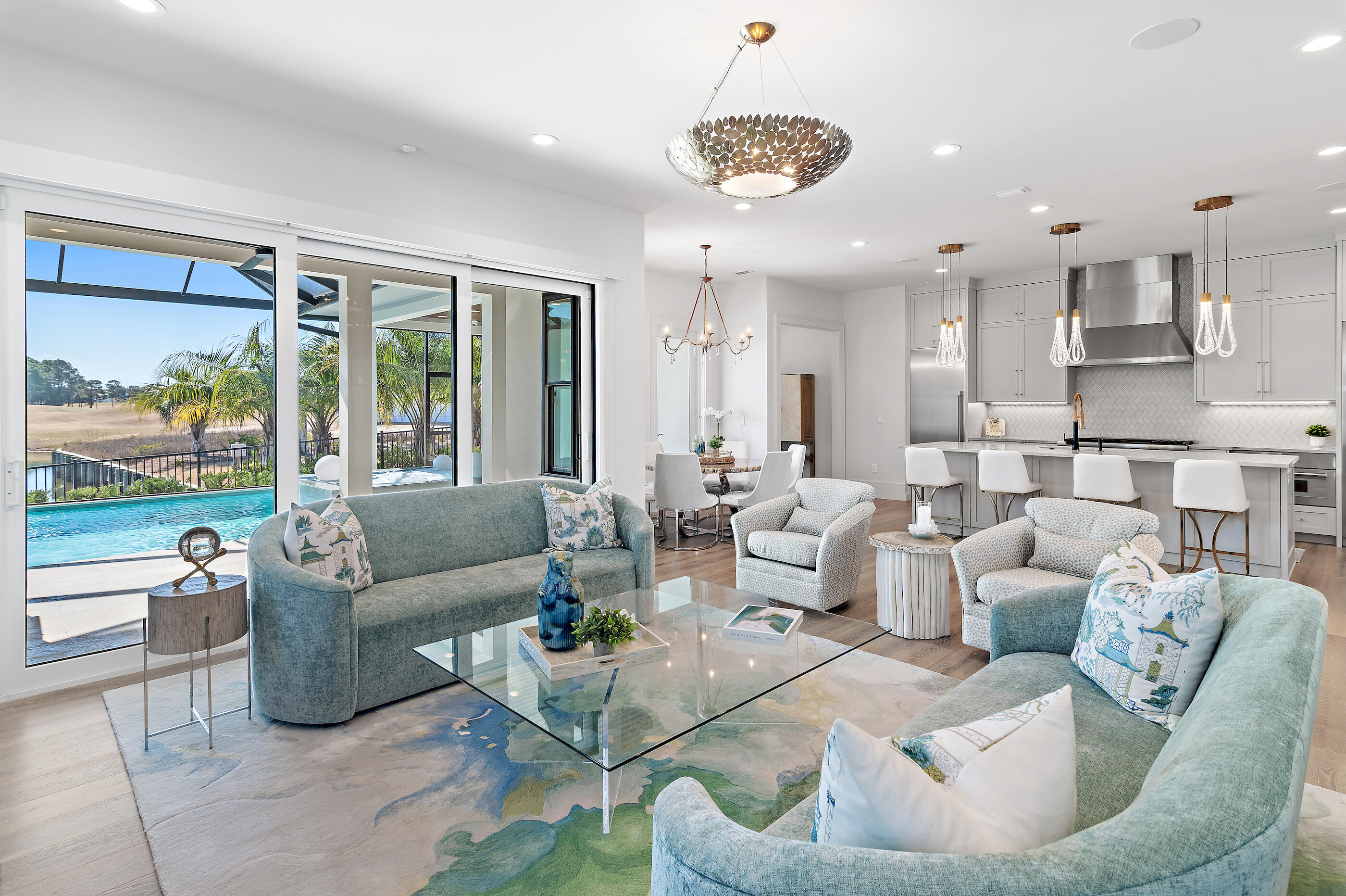 Seller is refreshening entire exterior with a new coat of paint! Located in Regatta Bay's newest community, Tradewinds, this exceptional luxury coastal home showcases refined craftsmanship and timeless design. Built in 2022 by Legendary Home Builders, the home features West Indies architecture with Dutch influence, thoughtfully curated for elegant coastal living. Offering 4 bedrooms, 4 full baths, 2 half baths and a 3-car garage, this smart home spans 3,078 sq. ft. of heated/ cooled living space and is filled with hand-selected designer finishes throughout. Hardwood floors flow seamlessly through the home, complemented by quartzite countertops, custom tiled showers and elevated details at every turn. The master bedroom is a true retreat, featuring a large walk-in closet, a spa-inspired bath with a soaking tub, and separate walk-in shower. A first-floor guest bedroom with private bath, powder room and spacious laundry room with sink provide both comfort and convenience. Designed for entertaining, the large gourmet kitchen is equipped with top-of-the-line features and opens to the expansive living area. Step outside to the screened outdoor living space with summer kitchen, private pool and spa and spectacular views of the lake and golf course the perfect setting for year-round enjoyment. Upstairs, a versatile bonus/flex space is joined by two additional bedrooms, each with private en-suite baths, offering privacy and flexibility for family or guests. Last but certainly not least the home offers and whole house generator. Built by Legendary Home Builders, utilizing only the finest materials and high end finishes such as: wind and impact resistant windows, wind and impact rated doors, insulated wind and impact rated garage doors, insulation in all interior walls for energy efficiency, sound proofing insulation between floors for sound barrier, stainless steel door hinges, custom wood shelving in all closets, Kohler plumbing throughout, custom solid wood cabinetry throughout with soft close hinges, surround sound, smart home technology, led lighting throughout and so much more...This remarkable home combines luxury, location, and lifestyle in one of Destin's most desirable gated communities. Regatta Bay is a serene, gated community that seamlessly blends golf and boating, offering a lifestyle that is truly unparalleled! The essence of the Regatta Bay Lifestyle revolves around convenience, allowing residents to easily access numerous enjoyable destinations within minutes via golf cart, including the beach! Within the community, residents can indulge in golf, swimming, tennis, pickleball, parks, playgrounds, the Regatta Bay Clubhouse, Legendary Marine, and Legendary Yacht Club. Furthermore, Regatta Bay features a private road that leads directly to the Destin Commons, where an array of popular retail stores for both men and women await, alongside a diverse selection of restaurants, Whole Foods, Bass Pro, Lowes, an AMC movie theater, and Uncle Buck's Bowling-all easily reachable by golf cart. Regatta Bay is centrally located offering easy access to the airport and only a few miles from Northwest Florida's finest hospital. Schedule your private tour today and experience the elegance of Regatta Bay living.