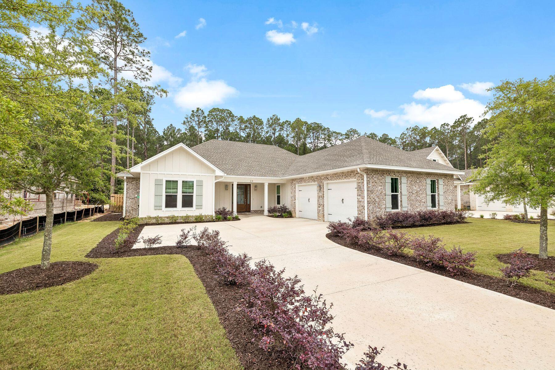 Tucked within the gated bayfront community of Steamboat Landing at Hammock Bay, this thoughtfully designed single-level residence offers an exceptional combination of privacy, functionality, and indoor-outdoor living. Positioned on a large homesite backing to a serene wooded buffer, the property enjoys a peaceful setting with a spacious fenced backyard designed for both entertaining and everyday enjoyment. Beautiful landscaping and a welcoming approach set the tone upon arrival, while the attached two-car garage and well-planned layout provide effortless convenience. The expansive backyard is a standout feature, complete with a large paver patio and grilling area, dedicated fire pit space, and an oversized screened porch with ample room for both dining and lounging, all overlooking the private natural backdrop. Inside, the home's flowing floor plan was designed with both comfort and connection in mind. A welcoming foyer opens into the spacious living room, anchored by a built-in brick fireplace, before seamlessly transitioning into the dining area and stunning kitchen beyond. The kitchen serves as the heart of the home with a large center island, gas range, range hood with natural wood accents, neutral tile backsplash, and an oversized walk-in pantry. Large windows throughout the living, dining, and kitchen spaces create a bright and inviting atmosphere while offering uninterrupted views of the backyard and wooded surroundings. Positioned at the rear of the home for maximum privacy, the primary suite overlooks the backyard and wooded buffer and features dual vanities, a walk-in shower, and a spacious walk-in closet. Two additional guest bedrooms each include walk-in closets and share a Jack-and-Jill style bathroom, while a separate powder bath adds convenience for visitors. Privately situated off the kitchen, a mudroom hallway and laundry area connect to a secluded fourth bedroom featuring its own ensuite bath and generous walk-in closet, ideal for guests or multigenerational living. Residents of Steamboat Landing at Hammock Bay enjoy an amenity-rich lifestyle with access to the expansive community offerings. Steamboat Landing provides a more intimate bayfront setting complete with a waterfront clubhouse, dock, and picturesque walking trails shaded by mature oak trees. Hammock Bay further enhances the lifestyle experience with multiple pools including two zero-entry resort-style pools, a traditional lap and recreation pool, a state-of-the-art 10,000-square-foot fitness center, more than 12 miles of trails and bike paths, playgrounds, lighted pickleball and tennis courts, and a basketball court, the popular Props Brewery, and a community amphitheater.