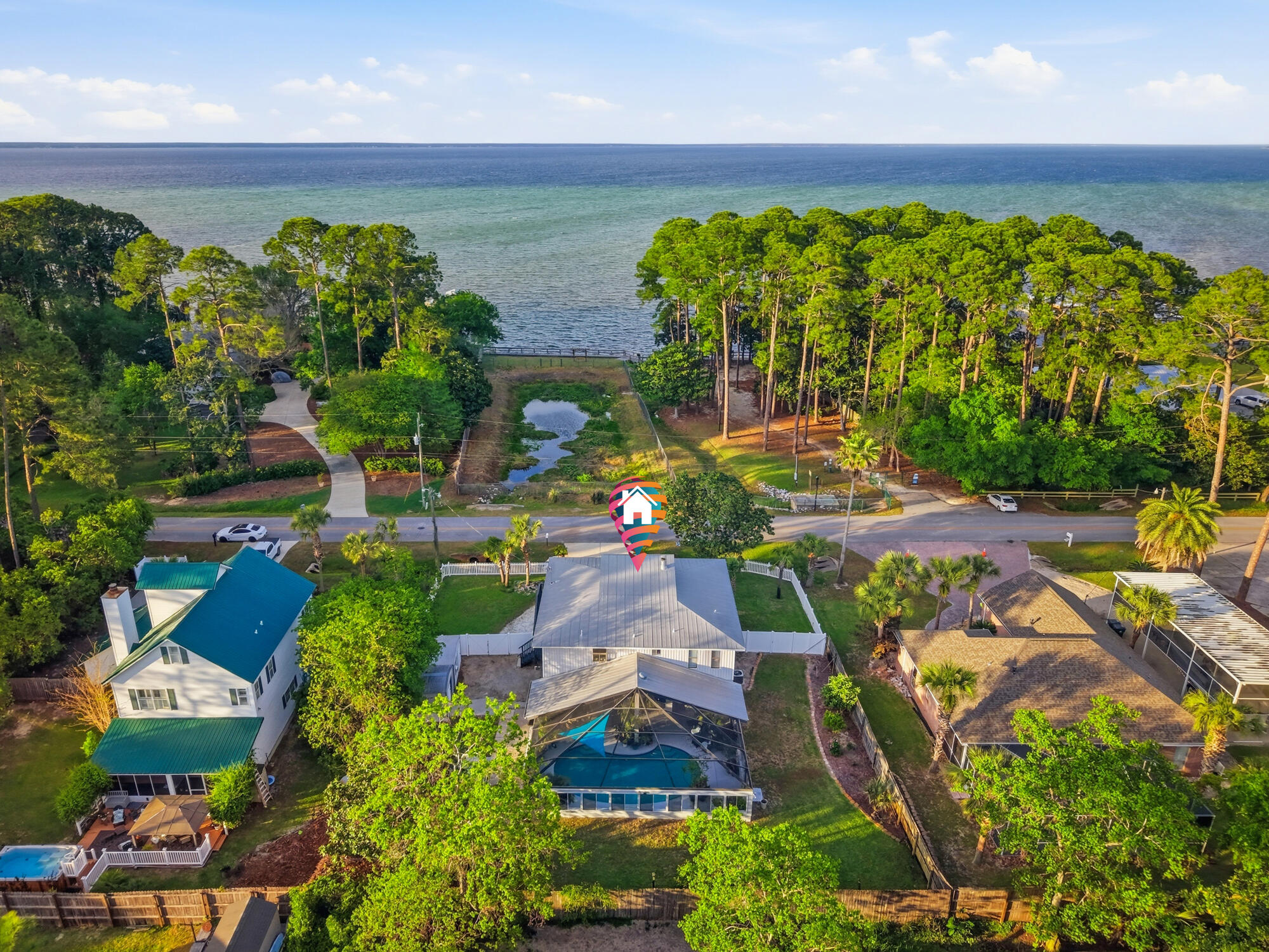 Positioned directly across from the bay and protected by a dedicated park, this exceptional residence offers permanent, unobstructed water views--a rare and highly sought-after setting where no future construction will ever compromise your outlook. This well-appointed home features 4 bedrooms and 3 bathrooms, complemented by a spacious two-car garage and a thoughtfully designed screened and covered pool enclosure--perfect for year-round enjoyment and effortless entertaining. The interior has been tastefully updated with a focus on both luxury and functionality. The kitchen showcases granite countertops, a five-burner gas cooktop, and double ovens, ideal for elevated everyday living. Bathrooms have been fully updated, while the living space is anchored by a striking electric fireplace- with a custom handcrafted black walnut mantle and shelving. A newly renovated balcony enhances the home's indoor-outdoor lifestyle.

Wake up to sweeping views of the Choctawhatchee Bay from the primary suite, and enjoy the same stunning backdrop from the living and dining areas. While the property does not include a private dock, convenient public bay access is just a short walk away--perfect for paddleboarding, kayaking, and fishing.

Additional features include a workshop, storage building, and greenhouse, offering versatility for hobbies or storage. The pool enclosure is a durable, heavy-duty structure with both covered and screened sections. Hurricane-impact windows on the main level front and side provide added peace of mind. The whole home is also equipped with a central vacuum system that is built in for a powerful whole-home cleaning without carrying a vacuum! Plus a 20 pound limit dumbwaiter(food/grocery lift) inside the laundry room and goes right up to the kitchen counter!

One of the property's most compelling advantages: no HOA and no fees. Bring your boat, RV, and all your toys--this home offers complete freedom with significant cost savings. An 8-foot privacy fence enhances seclusion, and a separate well supports the irrigation system.

Located on a quiet, well-maintained street surrounded by high-end homes, this property combines luxury, privacy, and long-term view protection--making it a standout opportunity for buyers seeking a distinctive coastal lifestyle.