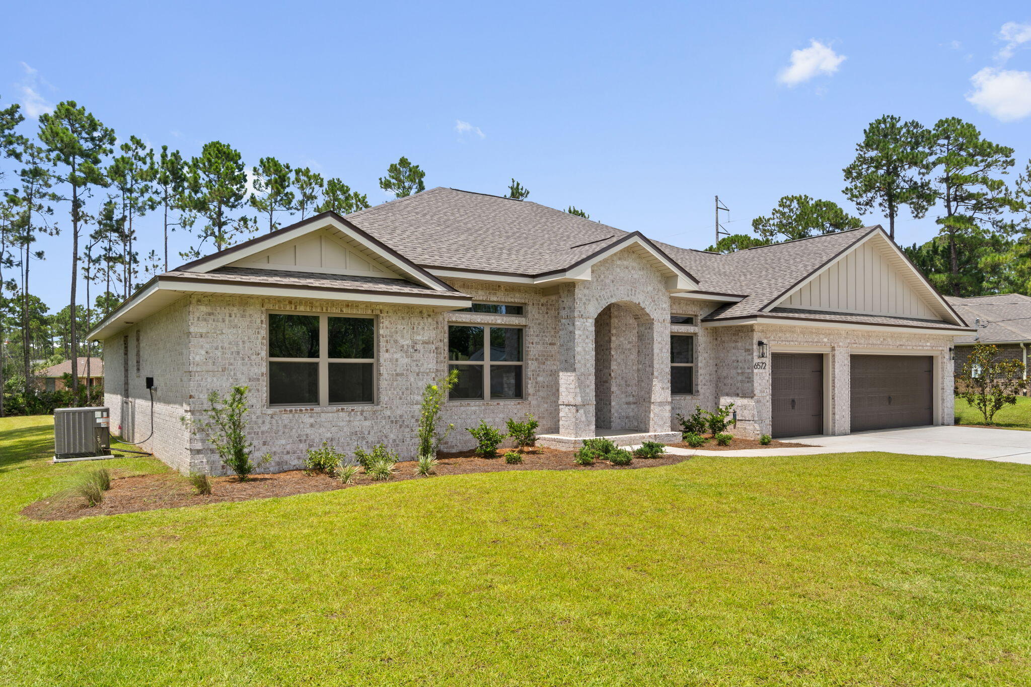 Complete and MOVE- IN Ready ~Luxury NEW Construction Custom-Built Home in Holley by the Sea!
Enjoy exclusive access to the renowned Holley by the Sea amenities--multiple pools, a fully equipped gym, tennis courts, waterfront park, and deeded access to Santa Rosa Sound. Ideally located within the community, this stunning 4 bed / 3 bath tri-split floor plan by Robbins Builders offers exceptional design,quality craftsmanship, and convenient access to Navarre Beach, shopping, and Hwy 98 to Hurlburt Field AFB.From the inviting foyer, the home opens to the formal dining room and dedicated office before flowing into the spacious open-concept living area. The gourmet kitchen is a showpiece with shaker cabinetry topped with crown molding, beautiful quartz countertops, tiled backsplash, stainless steel appliances  undermount sink, and an oversized wraparound pantry. A large center island connects seamlessly to the breakfast nook and family room perfect for everyday living and entertaining.
Wood-look staggered tile extends throughout the foyer, dining room, main living spaces, laundry room, and all bathrooms for a cohesive, high-end finish.
The owner's suite features a trey ceiling, ceiling fan, and an expansive bathroom with a large tiled shower, separate soaking tub, quartz double vanity with framed mirrors, and an impressive walk-in closet. Two generous secondary bedrooms each with solid door closets and ceiling fans share a full bath with tub/shower combo and linen storage....... A separate guest/teen suite offers its own full bath and direct access to the large covered back porch.
Additional features include a spacious laundry room and an oversized 3-car garage, ideal for trucks, equipment, or outdoor toys.
Situated on a 100 x 200 lot, the exterior includes a grassed yard with irrigation, sprinkler system, lawn pump and well, and a digital programmable timer for easy care. Build quality is enhanced by a TAEXX in-wall pest control system, Fabric Shield hurricane protection, and a dimensional shingle roof for potential insurance savings.
Upgrades throughout include crown molding, recessed lighting, framed mirrors, a deluxe lighting package, 50-gallon water heater, garage door remotes, and attic pull-down stairs.
Contact us today for details, color selections, and current construction status.
Photos are of previously completed homes colors, fixtures, and finishes may vary.**This home is planned for Natural colored cabinets in the kitchen and bathrooms with a black center island in the kitchen.