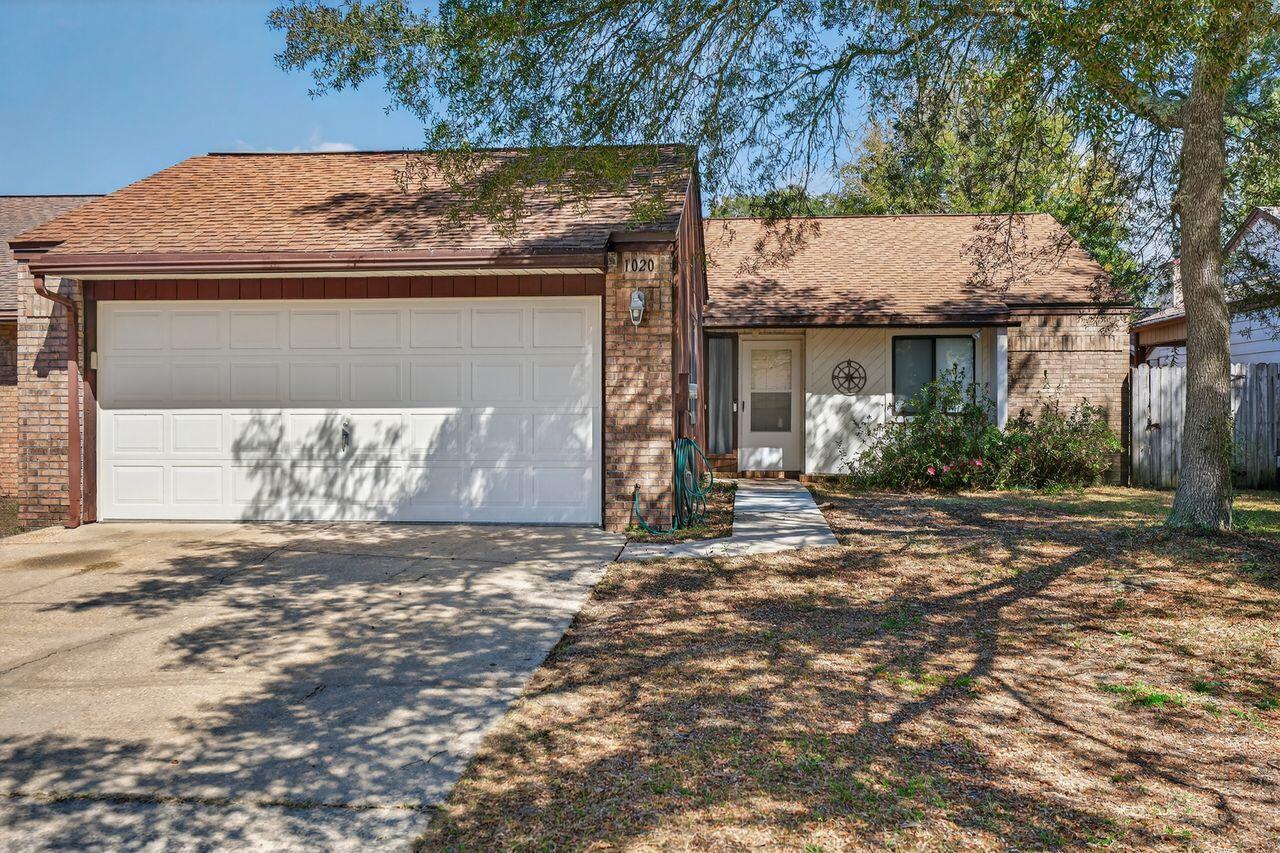 Back on the market--through no fault of the sellers!

Welcome to this delightful garden home in Niceville's desirable Cedar Ridge neighborhood with NO HOA, plus sidewalks and underground utilities. This 2-bedroom, 2-bath residence with a 2-car garage combines comfort and character in every room.

Recently painted and featuring new laminate flooring in the foyer, kitchen, and baths, along with brand-new carpet in the living room and bedrooms. The spacious living area boasts a cathedral ceiling and a cozy brick fireplace with appealing wood accents. The galley-style kitchen offers a gas range, original wood cabinetry, and a charming breakfast nook illuminated by a distinctive Tiffany-style light fixture.

Step outside to a private, fully fenced backyard with two covered porches--ideal for relaxing, entertaining, or letting pets play. Conveniently located and move-in ready, this home is waiting for its next owner. Schedule your showing today!