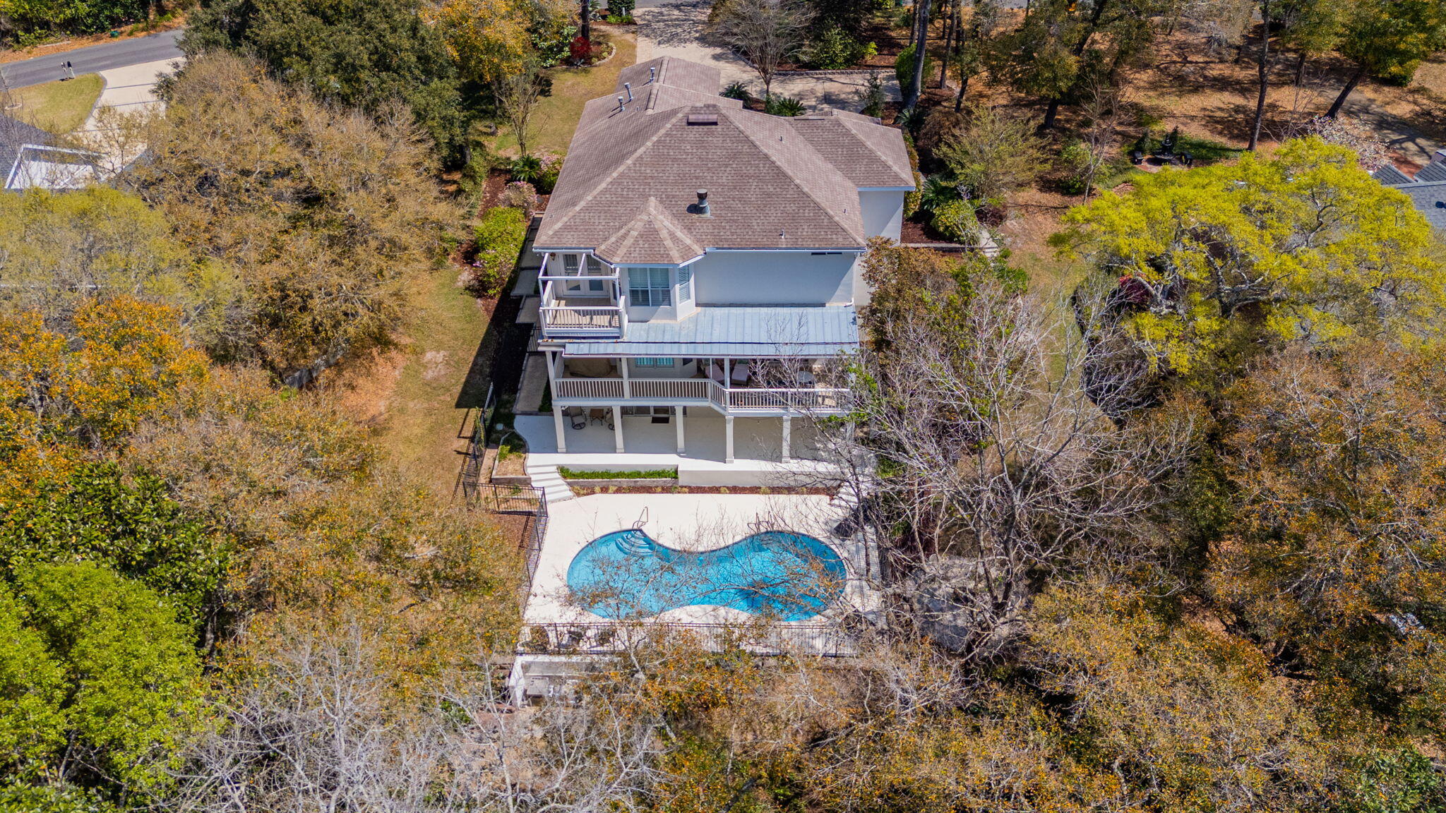 Located on a spacious and private 2/3-acre lot in Rocky Bayou Estates, 2760 Edgewater Drive represents a master class in contemporary luxury living and maintenance. This sprawling estate boasts a highly flexible three-story floor plan with six bedrooms and four bathrooms, including a fully appointed lower-level walkout perfect for multi-generational living or a high-end guest suite. The home's striking architecture boasts large windows allowing for a plethora of natural lighting, and vaulted ceilings in both the great room and primary bedroom, both of which feature cozy gas fireplaces for ambiance on chilly evenings. The home's gourmet kitchen underwent a complete renovation in 2021, resulting in quartz countertops, high-end recessed LED cabinetry lighting, and a large island with new gas stovetop. Every aspect of the home's interior has been meticulously updated, including 2019 Luxury Vinyl Plank flooring and a spa-inspired primary bathroom boasting an oversized tiled shower and private toilet room. Exterior living spaces have also received a complete transformation in late 2025, as evidenced by freshly painted surfaces on the entire home, decks, and patios. The home's exterior living spaces are centered on a large modern pool that received a complete reconditioning in 2025, complete with a new plaster finish, tile work, and a smartphone-enabled variable-speed whisper quiet pump. Evening hours are enhanced with professional Kichler LED lighting on both pathways and landscape areas. In addition to these high-end finishes and amenities, this home has been engineered for peak performance and peace of mind, boasting a whole home 25KW Generac gas generator, a brand new SEER2 Compliant Rheem HVAC system installed in 2023, and a fully encapsulated crawl space with an automated dehumidifier. From the specialized motorcycle/utility garage to the Z-Wave smart lighting and high-end whole home central vacuum, this stunning retreat in Niceville offers an unparalleled level of sophistication and move-in-ready assurance.
