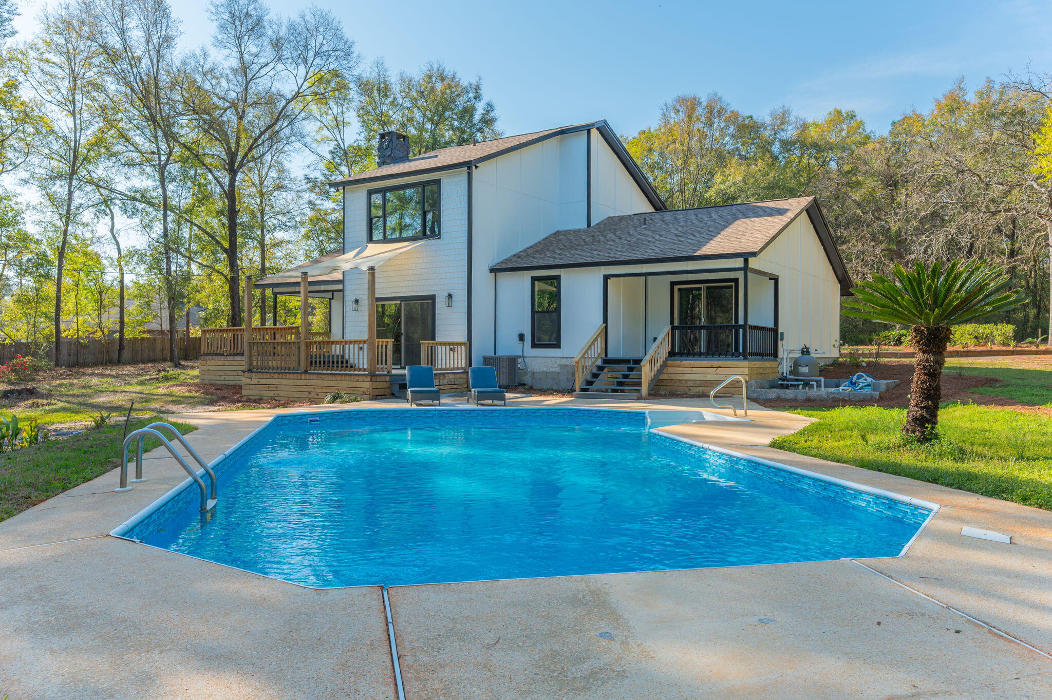 Welcome to your private estate in Crestview-nestled on 2 acres and set back nearly a quarter mile for ultimate privacy. Completely rebuilt from the ground up in 2024-2025, everything is brand new as of 2025: 2025 windows, 2025 doors, 2024 Hardie board siding, 2024 roof, 2024 plumbing, 2024 electrical, 2024 insulation, 2025 HVAC systems, kitchen, appliances, and bathrooms--even utility connections. Enjoy a large swimming pool, 550+ sq ft of decking, and a paved circular driveway with room for a future six-car garage. Inside features coastal-inspired design with shiplap, quartz countertops, tiled walk-in showers, designer fixtures, and light sandy oak LVP flooring. Fully permitted 2024 rebuild. This is essentially a new construction home with the charm of an established setting
