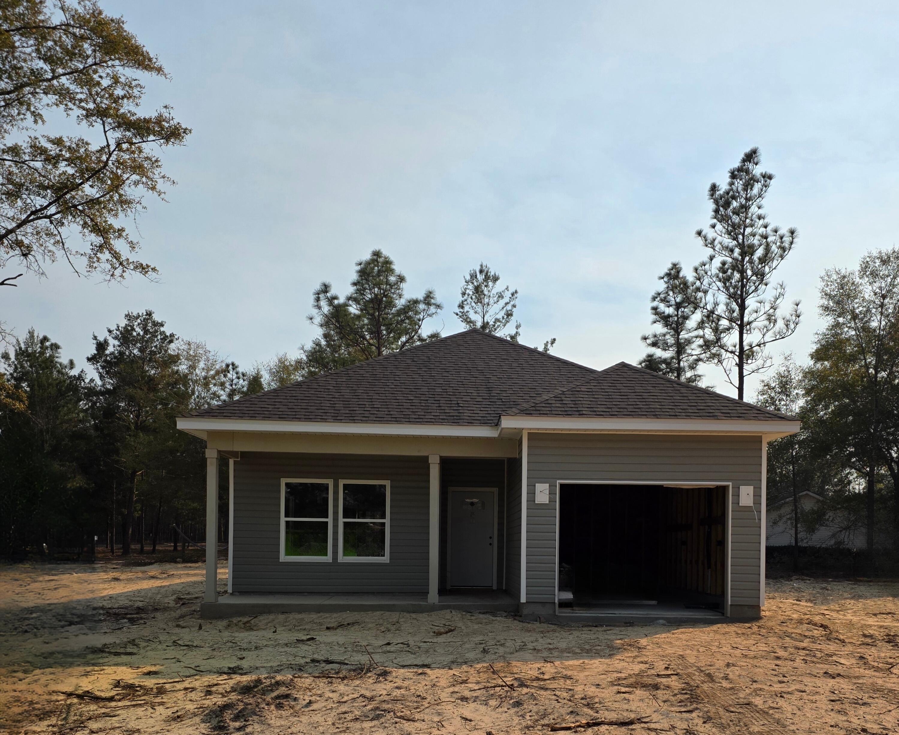 Beautifully crafted new construction home by Southern Home Solutions, a trusted local builder known for quality craftsmanship. This 3-bedroom, 2-bath home with a 1-car garage features an open and inviting layout with 9-foot ceilings, wall-to-wall LVP flooring, and ceiling fans in every room. The kitchen shines with quartz countertops and modern finishes, perfect for both everyday living and entertaining. Located in Flood Zone X, this home offers peace of mind and long-term savings. Enjoy the added confidence of a 1-year builder's warranty. Ideally situated just minutes from shopping, interstate for easy commute to neighboring cities,  beaches, the Springs, and the newly opened Shoal River Headwaters State Park.