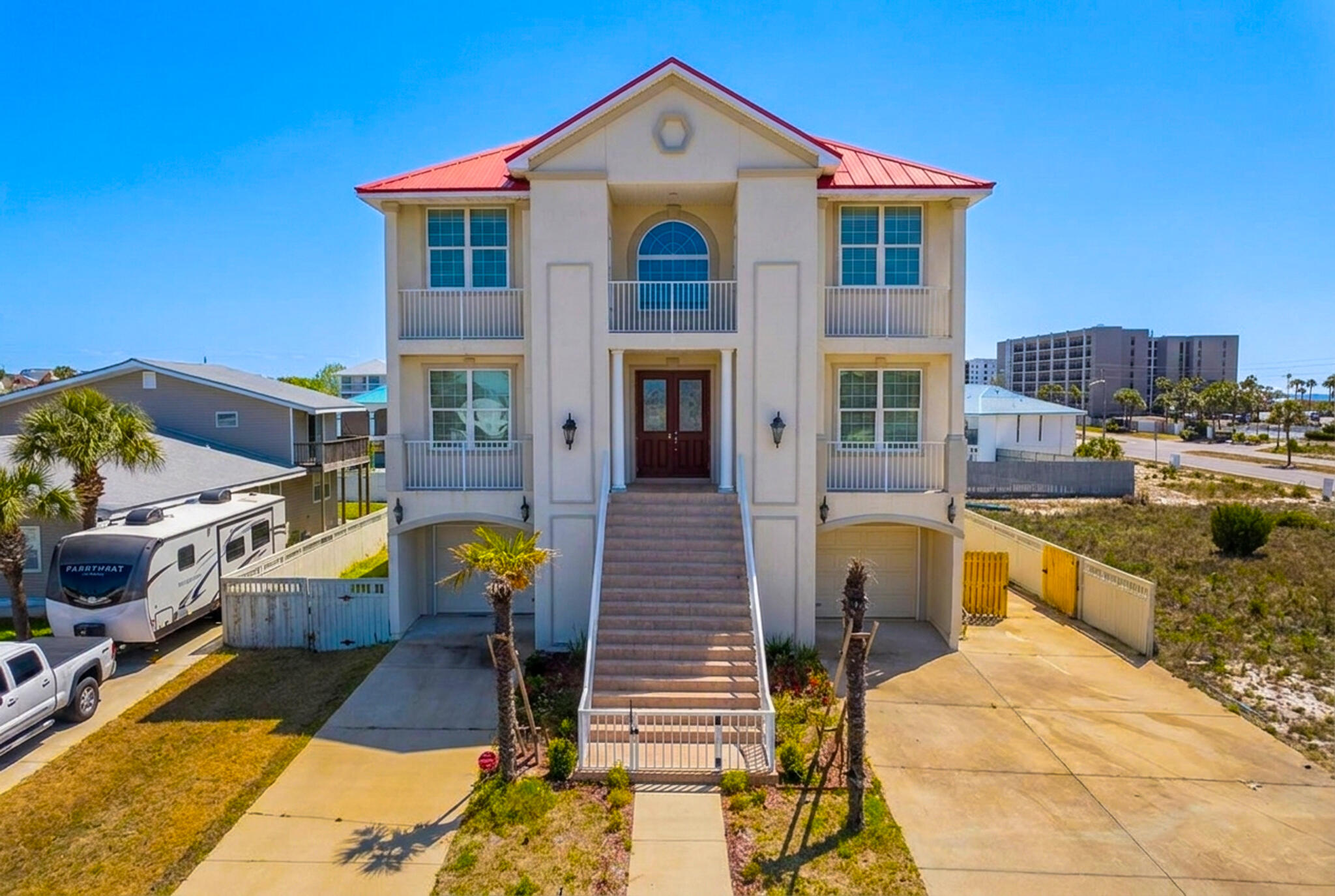 This spacious Gulf-view home, located directly across from beach access, is designed with families who love the beach in mind. From the moment you step inside, you're greeted by an elegant 20-foot foyer that sets a relaxed, coastal tone for unforgettable family time at the shore.

An impressive hardwood staircase, beautiful chandeliers, and warm, comfortable furnishings create an inviting atmosphere throughout the home. The large gourmet kitchen serves as the heart of the house, featuring a generous island with breakfast bar seating, granite countertops, white cabinetry, and stainless-steel appliances--perfect for cooking big family meals after a day at the beach.

The first floor offers incredible flexibility for family living and entertaining, with an additional family room, a full second kitchen with a gas range, a dining area, and two guest bedrooms. These spaces can easily double as a kids' hangout, game room, or movie night retreat.

Upstairs, the third floor includes another spacious family room and four additional bedrooms, giving everyone room to spread out and relax. Multiple covered decks on each level invite you to unwind together while enjoying Gulf breezes and sweeping sunset views over both the Gulf of Mexico and Santa Rosa Sound.

With its generous layout, multiple gathering spaces, and unbeatable beachside location, this home is perfect for families who want to make lasting memories by the wate