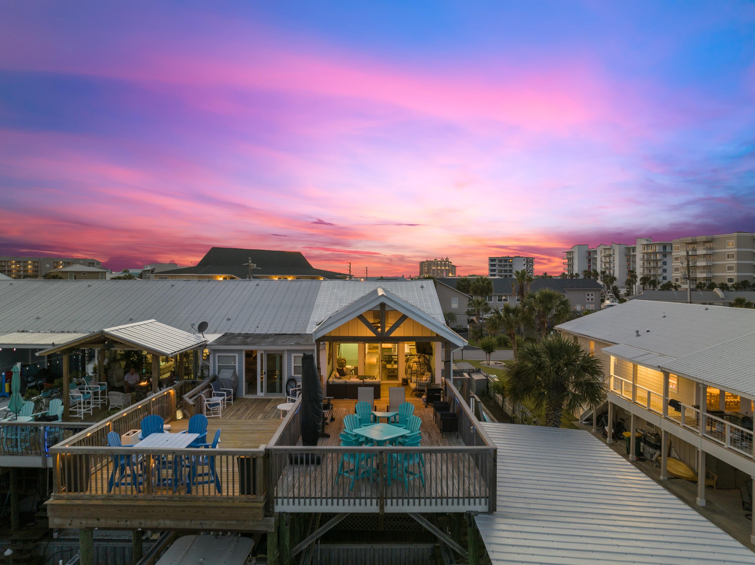 Waterfront living meets beach lifestyle in this beautifully remodeled townhome featuring two covered boat lifts and private beach access just a short walk away. Perfectly positioned on a wide canal, you'll enjoy easy boating with quick access to Destin Pass, the Gulf of Mexico, and Crab Island in under 15 minutes by boat. Designed for entertaining, the expansive waterfront deck offers plenty of space to relax, dine, or unwind by the fire pit while enjoying sunrise views. A hot tub, covered lanai, and private dock create the ultimate outdoor retreat.

Inside, the home has been thoughtfully updated with a custom kitchen featuring an 8-foot butcher block island, granite countertops, stainless steel appliances, and a spacious pantry. The lower level includes a custom wet bar with wine cooler, beverage cooler, ice maker, and live-edge cypress countertop, plus a second living area that could easily serve as a game room to maximize vacation rental appeal.

Additional highlights include two deep-water slips with 8,000- and 10,000-pound covered lifts, a fenced maintenance-free side yard, and room to enjoy kayaking, paddle boarding, fishing, or simply stepping onto your boat from your backyard. Offered furnished, this is a rare opportunity to own a turnkey waterfront property that combines boating, beach access, and exceptional outdoor living in the heart of Destin.