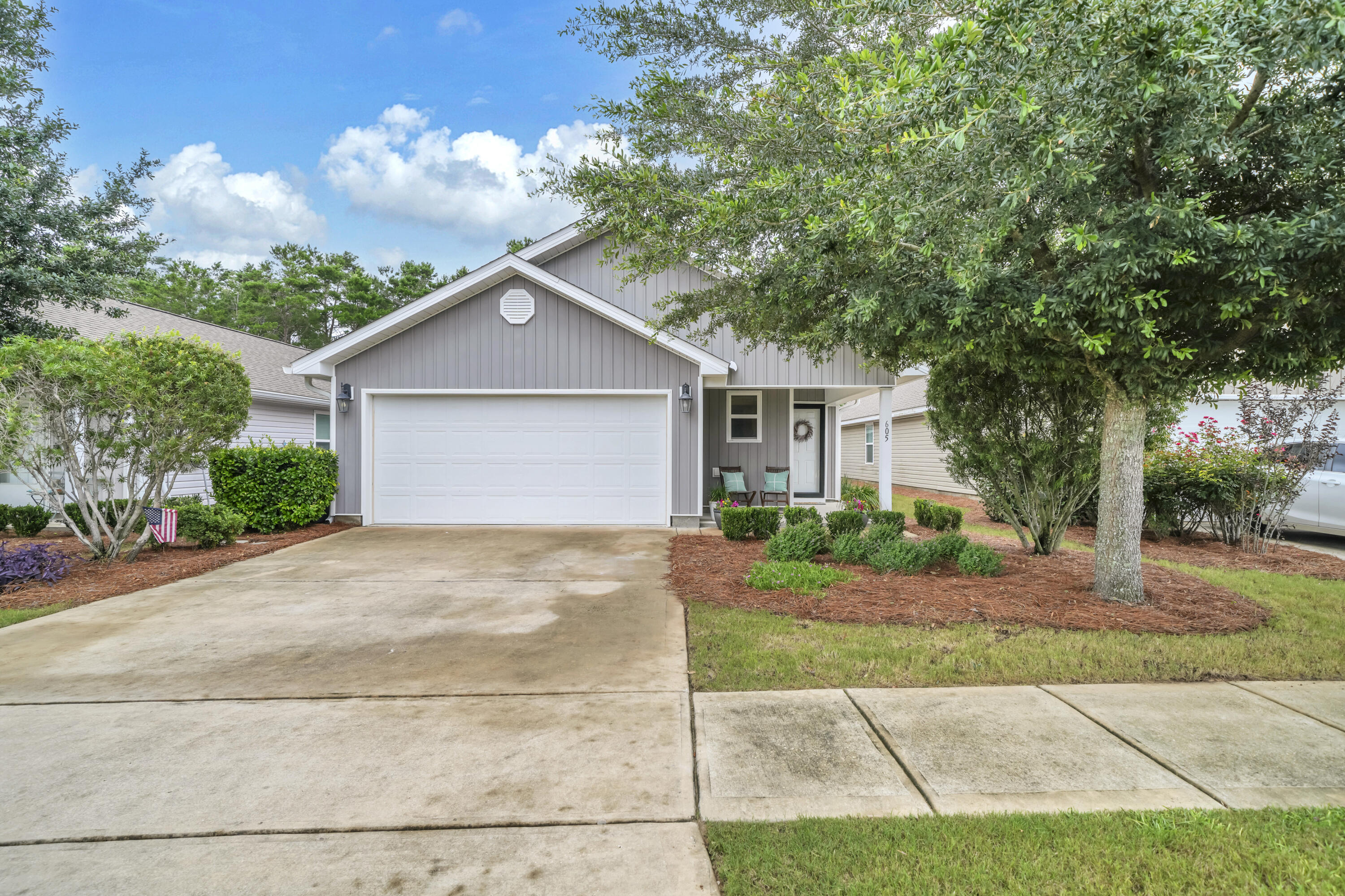 Welcome to 605 Earl Godwin Road in the sought-after Crescent Mill neighborhood of Hammock Bay! Built in 2019, this beautifully maintained 3-bedroom, 2-bath home offers 1,646 square feet of thoughtfully designed living space and one of the most attractive entry points into one of Northwest Florida's premier master-planned communities.

Inside, you'll find an open-concept floor plan that seamlessly connects the living, dining, and kitchen areas, creating the perfect space for everyday living and entertaining. The kitchen has been enhanced with updated cabinetry, offering both style and functionality. The spacious primary suite and two additional bedrooms provide comfortable accommodations for family, guests, or a home office.

Step outside to enjoy your own private backyard retreat. The fully fenced yard backs to a peaceful wooded preserve, providing added privacy and a natural backdrop. Relax year-round on the screened porch or gather with friends and family on the extended paver patio, perfect for outdoor dining and entertaining.

Living in Crescent Mill means enjoying a low-maintenance lifestyle, with HOA dues covering lawn maintenance and basic cable service. Residents also have access to Hammock Bay's incredible amenities, including resort-style pools, fitness center, sports courts, walking and biking trails, parks, playgrounds, and the community clubhouse. Enjoy a vibrant social calendar with monthly farmers markets, live music, seasonal celebrations, and community events that make Hammock Bay one of the area's most desirable places to call home.

Whether you're a first-time buyer, downsizing, or looking for a move-in-ready home with exceptional amenities, this property offers an outstanding opportunity to enjoy the Hammock Bay lifestyle at an exceptional value.

Disclaimer: All information is deemed reliable but should be verified by the buyer as desired.