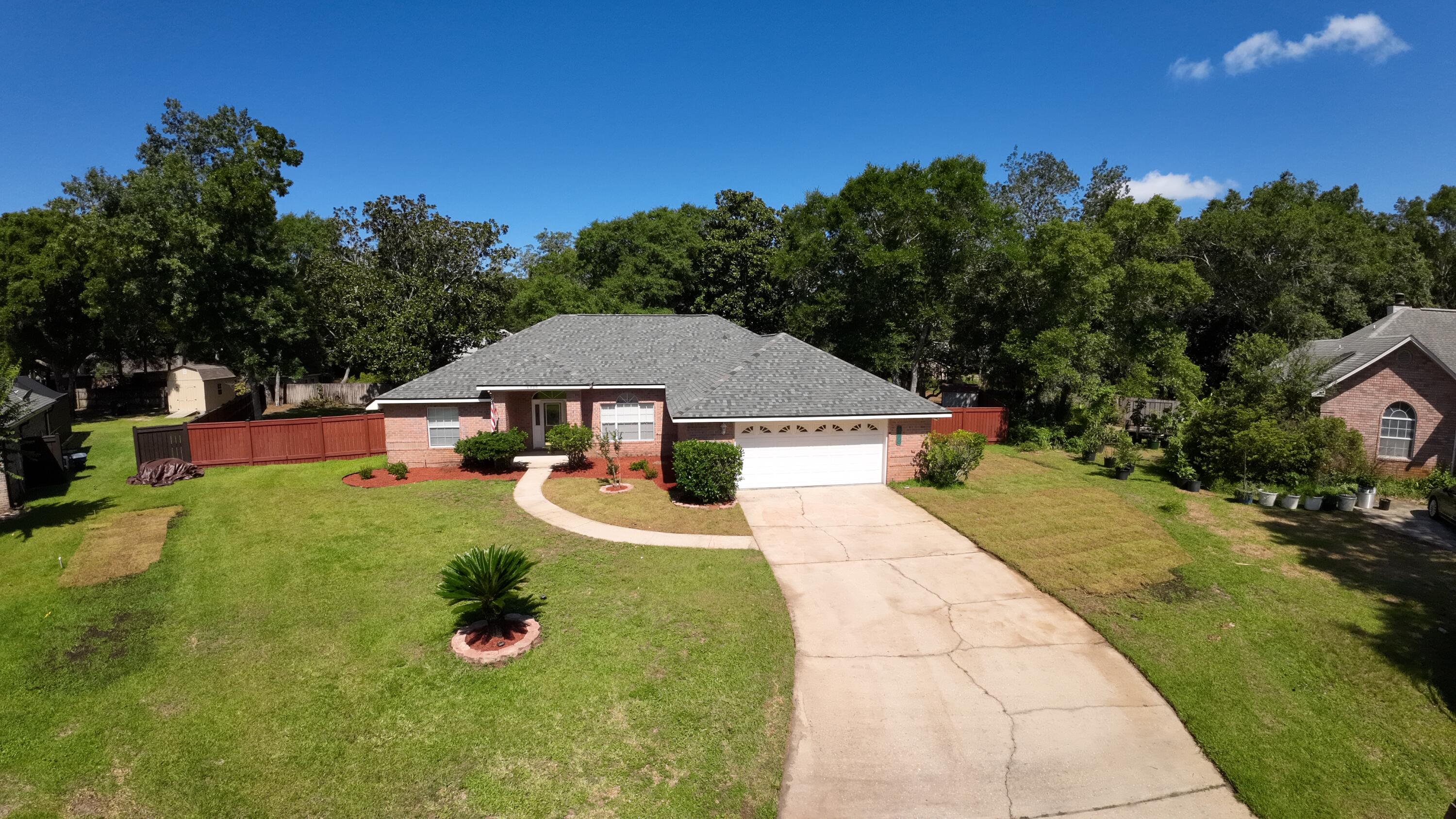 Welcome to 6900 Calle De Caballero, where spacious living meets the relaxed coastal lifestyle Navarre is known for. Situated on a beautifully maintained 0.507-acre lot in the desirable Robledal Estates community, this 3-bedroom, 2-bath home offers over 2,000 square feet of thoughtfully designed living space. Inside, you'll find luxury vinyl plank flooring, a spacious living room anchored by a cozy wood-burning fireplace, a formal dining room, and a bright breakfast nook overlooking the backyard. The well-appointed kitchen features stainless steel appliances, abundant cabinetry, and generous prep space, while the private primary suite offers tray ceilings, two walk-in closets, and a relaxing ensuite bath.

Step outside to enjoy the privacy and room to spread out that larger homesites provide. Located just minutes from Navarre's world-famous white sugar-sand beaches and emerald Gulf waters, you'll also enjoy convenient access to boating, fishing, shopping, dining, Hurlburt Field, and top-rated schools. As an added bonus, homeowners have the optional opportunity to join Crab Inc., providing access to community waterfront amenities and enhancing the coastal lifestyle. Don't miss your chance to own a beautiful home in one of Navarre's most established neighborhoods!