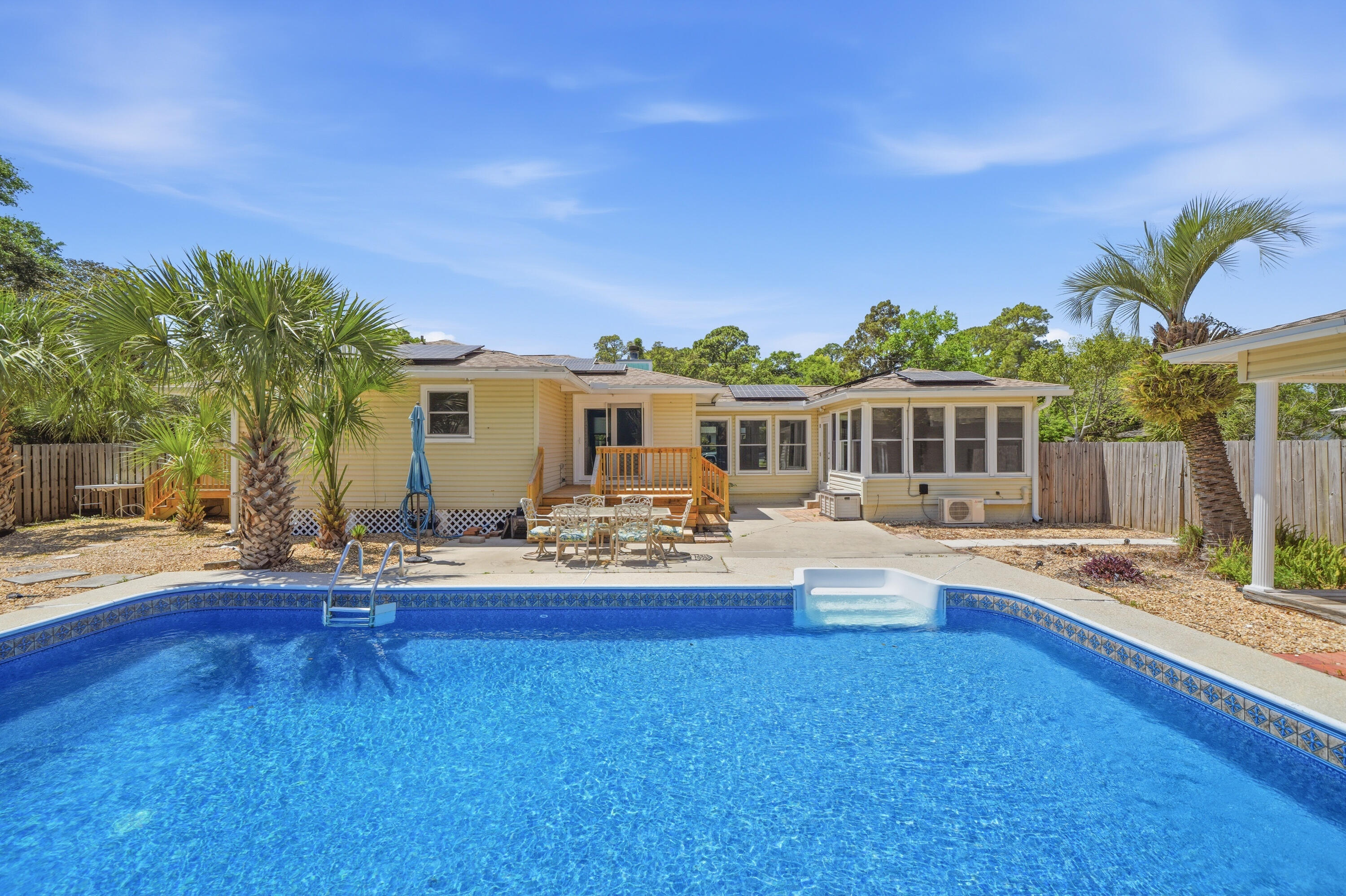 Welcome to this beautifully remodeled home by Randy Wise Homes offering modern upgrades, multiple living spaces, and exceptional outdoor living. Inside features fresh paint, updated flooring, an open layout, fireplace, built-ins, and a stunning renovated kitchen with quartz countertops, stainless steel appliances, double ovens, gas range, and oversized island. The vaulted sunroom with exposed wood beams provides the perfect space to relax or entertain. Bathrooms feature updated walk-in showers with built-in seating. Step outside to your private backyard retreat complete with an in-ground pool, spacious entertaining areas, and detached cabana with full bath.  An additional bonus flex space attached to the 1-car garage makes a perfect office, studio, or lounge area. Conveniently located near shopping, dining, schools, and major roadways in Fort Walton Beach.