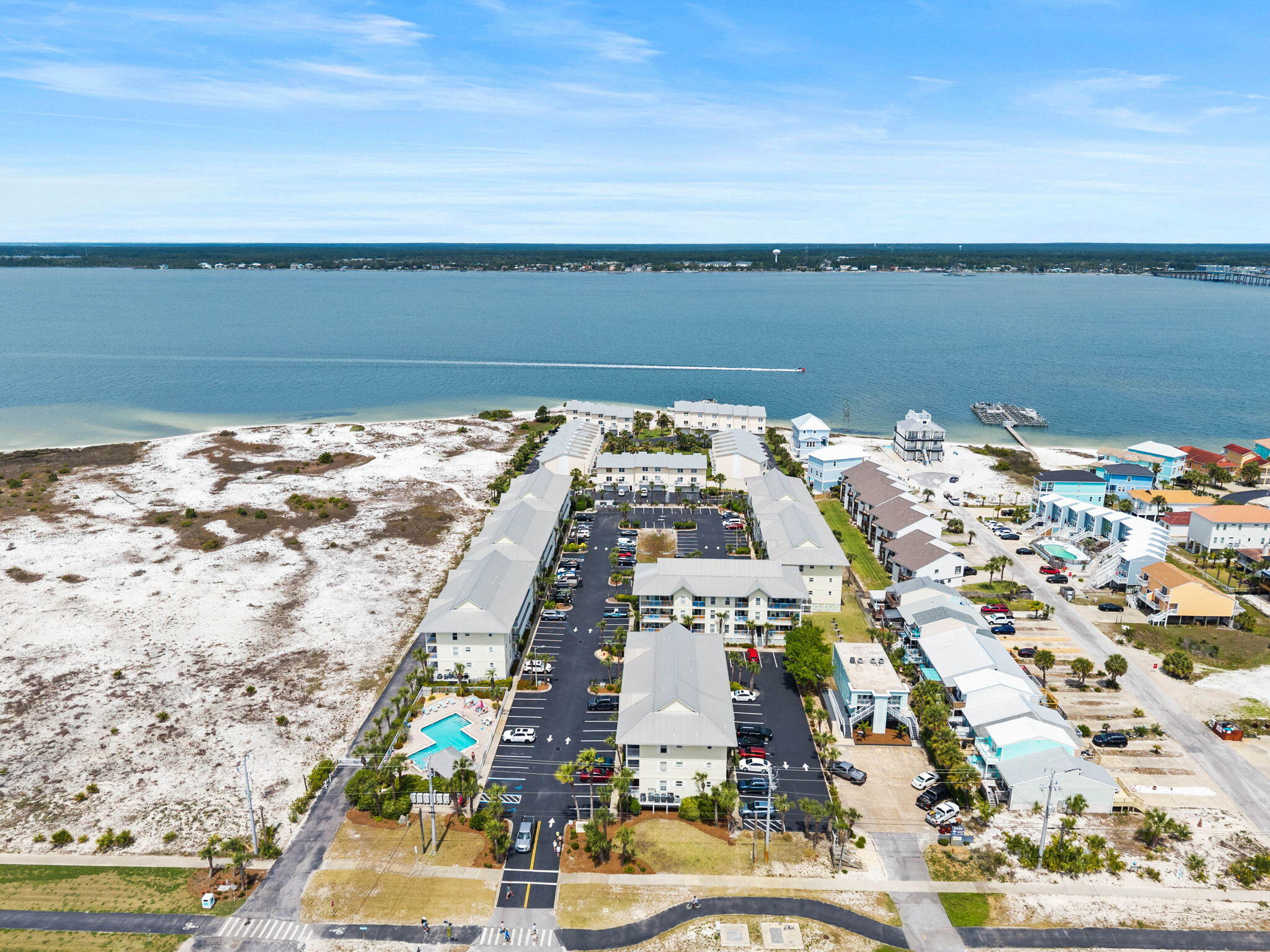 Experience the ultimate vacation lifestyle in this updated Gulf Island condo, boasting stunning views of both the Sound and the Gulf. Completely refreshed with modern touches and a proven short-term rental history, this unit is a premier investment opportunity. The interior features a modern finishes with the kitchen showcasing granite countertops, a new tile backsplash, and stainless steel appliances, while and both bathrooms were updated with new cabinets and stone counters. With a spacious bedroom and built-in hallway bunk beds, the layout comfortably sleeps six. Significant recent upgrades include a new AC unit (2026), fresh paint, new lighting, and new window treatments, ensuring a maintenance-free experience. Perfectly situated just steps from the Sound's calm white-sand shoreline   with Gulf beach access directly across the street, the complex also offers a pool with restrooms and showers, grilling areas, and association-provided cable and trash. This property is truly turnkey; the sellers are including all major furniture, making it ready for immediate guests or personal enjoyment. Don't miss your chance to own a piece of paradise. Schedule your tour today!