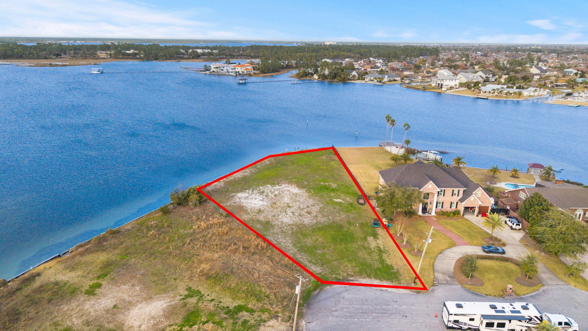 Incredible WATERFRONT OPPORTUNITY offering .76 ACRES of pristine, pure Bay views and approximately 232 feet of water frontage. This is the perfect homesite to build the forever dream waterfront home in Florida. 

With NO HOA making it highly desirable, this homesite is in one of Lynn Haven's most charming and sought-after waterfront neighborhoods in the Northshore area. Tucked away at the end of a cul-de-sac, this bayfront homesite provides beautiful open water views, a seawall already in place and is cleared, ready to build. A dock may be constructed to enjoy all that the waterfront lifestyle in Florida can offer. At just 4.8 nautical miles to the open Gulf of America, you'll be in the open Gulf waters in minutes, an easy trip to Shell Island on the weekends with the locals and be home for dinner to put fresh Snapper and Grouper on the table! This is the kind of property where you can truly enjoy the coastal lifestyle and capture a waterfront homesite that will stay in the family for years to come. Launch the boat from your future dock, spend the day fishing or cruising, paddleboard along the shoreline, or relax in your backyard watching the sunset over the Bay. 

Despite the peaceful setting, you're just minutes from the restaurants, shops, marina, and waterfront events in Lynn Haven, Florida, and a short drive to Downtown Panama City and the white sandy beaches. The homesite is large enough to accommodate an estate-sized home with a pool, carriage house, pole barn and so much more. Make this residence what you've always dreamed with no restrictions from an HOA! 

Large bayfront properties like this rarely come available. Build your dream waterfront home and enjoy boating, sunsets, and the relaxed coastal lifestyle right in your backyard.