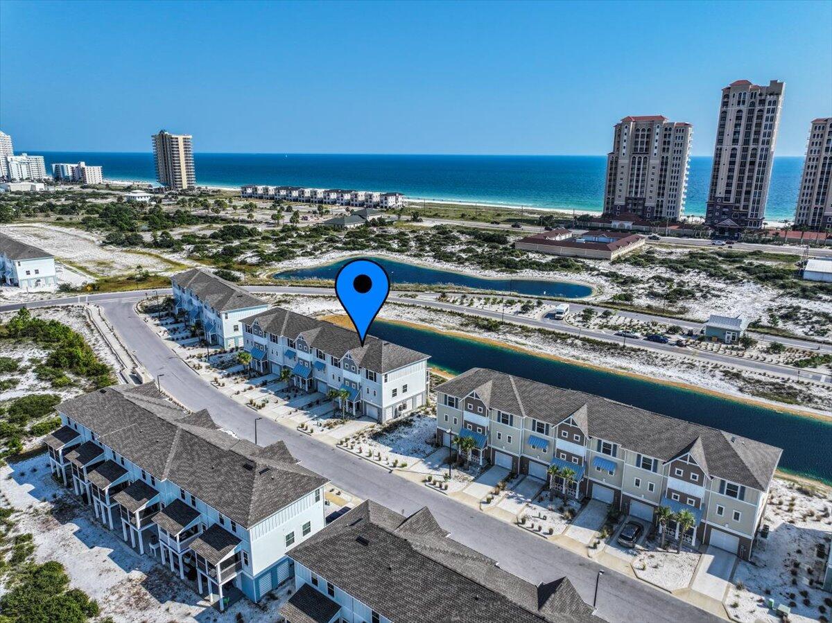 Looking for your escape to Perdido Paradise? This 3 bedroom, 2.5 bath FULLY FURNISHED (with some exclusions) townhome in the Lost Key Golf & Beach Club is waiting for you! Located in the heart of Perdido Key - convenient to shopping, dining, nightlife, and more! Not to mention all of the fantastic amenities that Lost Key has to offer - including the waterfront Lost Key Beach Club to grab a bite to eat and enjoy the private Beach access, an amazing zero-entry Olympic size swimming pool, fitness center, and you can become a member of the Lost Key Golf Club! This townhome offers 3 stories of space. The first floor is a 2 car tandem garage to stow all of your water toys and beach gear. Up the stairs to the second floor, you'll find your main living area. Complete with a full kitchen with shaker style cabinets, gorgeous quartz countertops, stainless steel appliances, and a breakfast bar that looks out into the dining area and living room. A slider door leads you to the screened in patio with fantastic water views and the perfect spot to catch the Blue Angels fly by. The 3rd floor hosts the laundry room, full guest bathroom, and all of the bedrooms - including the primary suite with ensuite featuring a double vanity and Tiled walk-in shower. With excellent rental history, and loads of activities to do in the area, this is a can't beat property! Schedule your showing today!
