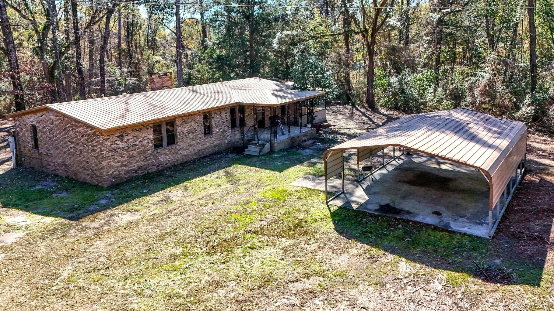 Riverfront property with just over 4 acres, no HOA, and plenty of room for boats, RVs, equipment, and outdoor recreation. Located near the Choctawhatchee River Bridge and public boat ramps, this property offers the space and flexibility that's becoming increasingly difficult to find.

This 3-bedroom, 2-bath brick home offers 2,278 square feet with a spacious floor plan, updated kitchen, large living area with fireplace, and an enclosed sunroom overlooking the property. The kitchen features custom cabinetry, stainless steel appliances, a gas range, and center island. The primary suite includes a walk-in closet and updated bath with double vanities.

Outside, you'll find multiple outbuildings, workshop space, storage buildings, oversized covered parking for boats and RVs, and plenty of room for hobbies, projects, and recreational equipment. A private well, septic system, natural gas, metal roof, and abundant parking add to the property's appeal.

An additional parcel (36-1N-17-04040-00B-0050) containing approximately 0.247 acres is included in the sale, bringing the total acreage to approximately 4.07 acres. Whether you're looking for a full-time residence, weekend retreat, or a property with room to spread out and enjoy the outdoors, this unique property offers endless possibilities.