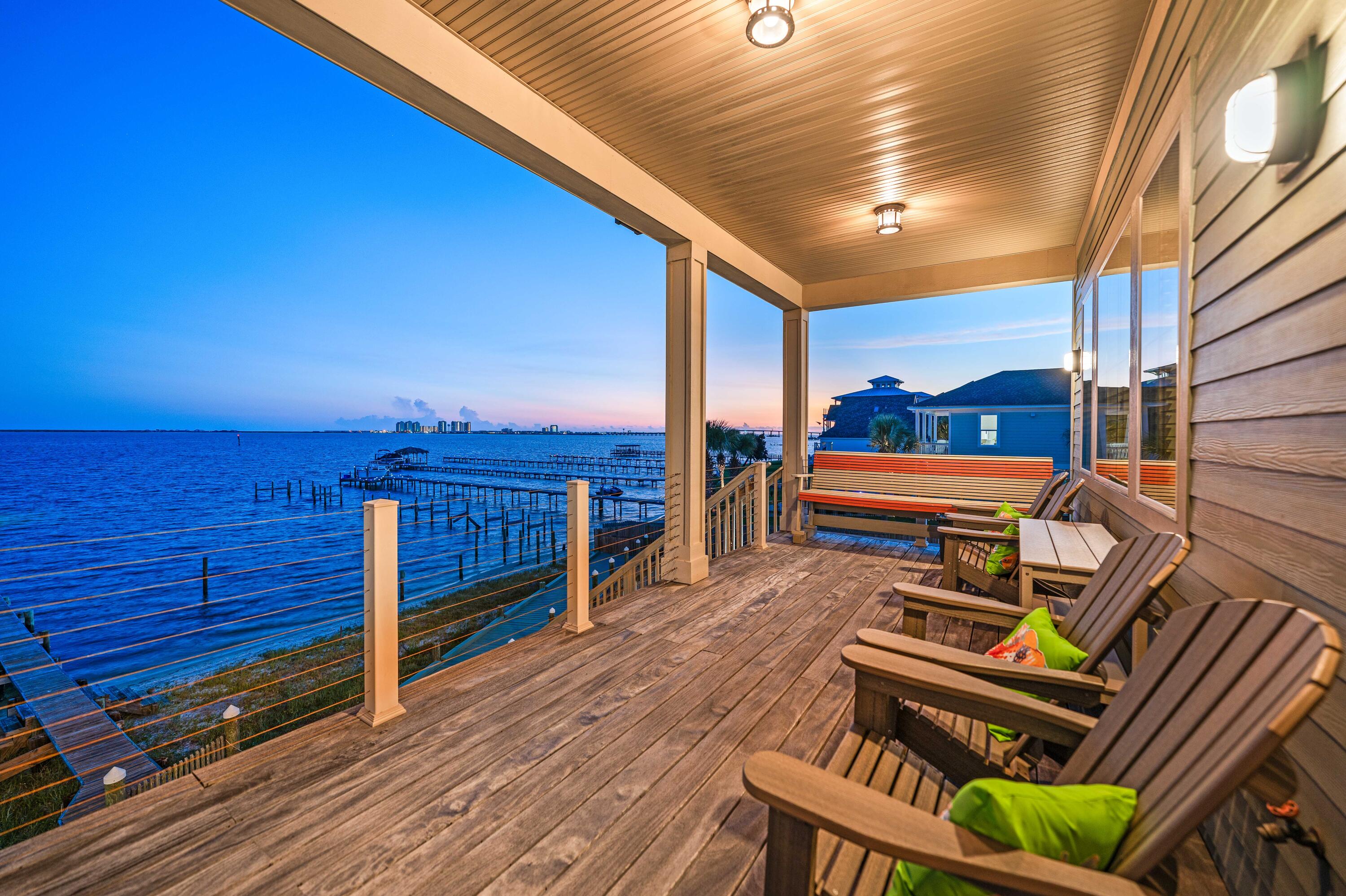 Rare Soundfront Double Lot | 101' Santa Rosa Sound Frontage | Private Boat Dock | Navarre, FL 32566
Some properties stop you in your tracks -- this is one of them. Set along the shimmering shores of the Santa Rosa Sound, 8944 Windgate Cir offers 101 feet of combined soundfront footage, a private boat dock, and sweeping views stretching all the way to the Gulf of Mexico. Located in Flood Zone X, this extraordinary Navarre waterfront estate sits on two separate lots -- 61' and 40' of respective frontage -- giving you the rarest of combinations: breathtaking beauty and unmatched optionality.
Keep both lots and create your dream outdoor retreat - a resort-style pool and spa, a putting green, or a waterfront cabana with fireplace.... Or sell the second lot separately and let the land work for you. However you choose to use it, this is Navarre waterfront living at its absolute finest.
A Custom Home Crafted for the Way You Want to Live.
This 2,770 sq ft custom residence offers 3 bedrooms, 2 full baths, 2 half baths, and a versatile flex space that adapts to your lifestyle -- whether you need a home office, private lounge, or creative studio. The thoughtful split floor plan ensures privacy throughout, while the open-concept second floor -- with soaring 10-foot ceilings -- delivers panoramic Sound views from every communal space.
Step inside and the craftsmanship speaks for itself. Wide plank heart pine floors, hand-selected and reclaimed from an Old Crow Distillery warehouse, run beneath 1x6 pine ceilings in the main living areas and primary suite. Tumbled stone showers and antique-refurbished vanities bring warmth and character to every bathroom -- the kind of detail you simply can't replicate with new construction.
At the heart of the home, the chef's kitchen is built to impress. An oversized granite island anchors the space, flanked by a world-renowned La Cornue 5-burner range and antique armoires ingeniously repurposed as one-of-a-kind cabinetry. It's a kitchen that's as beautiful as it is functional -- and one you'll never want to leave.
Soundfront Primary Suite -- An Entire Floor, All Your Own
The primary suite doesn't share its floor with anyone. Occupying the entire third level, this private retreat features a balcony that overlooks the Santa Rosa Sound, a flex space perfect for a home office or sitting room, and water views that greet you every single morning. It's not just a bedroom -- it's a sanctuary.
Room for Everything -- and Everyone
The finished, air-conditioned garage is a bonus living space all its own. With capacity for up to 6 vehicles, built-in cabinetry, sectional hobby and recreation areas, a half bath, and an additional laundry room, it's the kind of space that makes everyday life easier -- and it's not even counted in the home's square footage. Add four more driveway spots, a whole-house Generac generator, a tankless water heater, and two full laundry rooms, and you have a property that's as practical as it is spectacular.
Florida's Best Kept Secret -- Right Outside Your Door
Navarre Beach consistently earns its reputation as one of Florida's most pristine and peaceful coastal destinations, and this home puts you minutes from all of it. Cast a line from the Navarre Beach Fishing Pier, explore miles of dedicated bike and walking trails, or spend your days within the breathtaking Gulf Islands National Seashore. When you're ready for more, Pensacola Beach is just beyond the National Seashore -- offering vibrant dining, shopping, and waterfront entertainment.
This is more than a home. It's a rare opportunity to own one of the most distinctive soundfront properties on the Gulf Coast -- where masterful design, premier amenities, and the best of the Northwest Florida lifestyle come together in one extraordinary address.
=Í 8944 Windgate Cir, Navarre, FL 32566 | Soundfront Double Lot | Flood Zone X | 101' Santa Rosa Sound Frontage | Private Boat Dock | Navarre Beach Real Estate