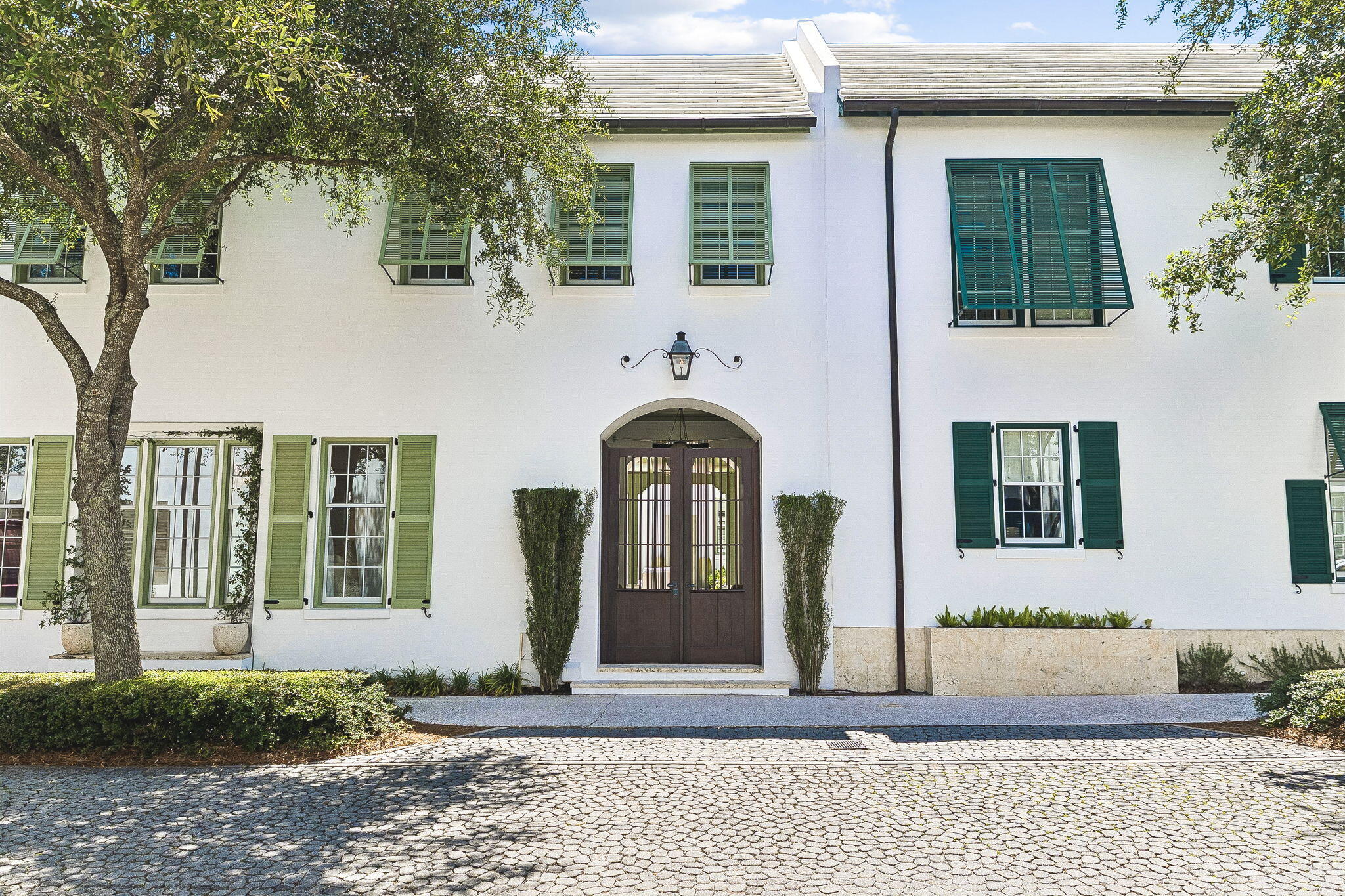 Nestled within the heart of Alys Beach, this three bedroom courtyard home designed by architect Steve Mouzon combines timeless architecture with exceptional comfort. The main living spaces open to the courtyard, creating an effortless flow for everyday living and entertaining. 

A private breezeway leads to the first-floor primary suite which exudes a resort like ambience and features direct courtyard access, a two-way fireplace, dual vanities, a soaking tub, and an outdoor shower. 

Upstairs, two guest suites offer well-appointed accommodations with generous closets and private baths, while a flexible landing provides space for an office or sitting area. 

Interior features include Dominican shell stone flooring, custom red gum hardwood cabinetry and wall paneling, a limestone kitchen island, and a spacious living and dining area filled with natural light. The courtyard serves as the centerpiece of the home, complete with a water feature, outdoor kitchen, and multiple gathering spaces. The house is being sold fully furnished with professionally designed interiors.