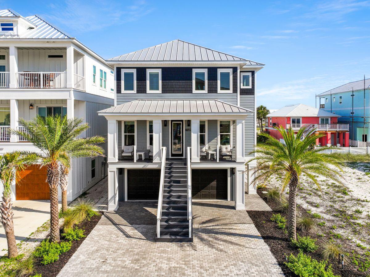 Live the Beach Life in Luxury! This fully furnished, turnkey 2020 Acorn Custom Home in the sought-after Grand Navarre community offers coastal elegance, modern technology, and peace of mind. This meticulously maintained 3-bedroom, 2.5-bath home has never been rented and is designed for effortless living and entertaining. Built to current coastal standards with pilings, fiber cement siding, secondary water protection, a metal roof, and impact-resistant windows and doors, this energy-efficient home is engineered for the Gulf Coast lifestyle. Features include high ceilings, crown molding, premium finishes, an electric fireplace, and an open-concept floor plan filled with natural light. Luxury upgrades include a custom elevator, geothermal HVAC, foam insulation, smart home technology, surround sound, remote-controlled shades, LED lighting, keyless entry, and a security system. The chef's kitchen boasts dual islands, quartz countertops, custom cabinetry, and premium Thermador appliances. The spacious primary suite features a walk-in closet and spa-inspired bath. Outdoor living includes a covered deck, gas fire pit, professional landscaping, irrigation system, and views of Santa Rosa Sound. The oversized three-car garage offers workshop/gym space and includes a six-seat golf cart. Just minutes from Navarre Beach, dining, boating, and Gulf Islands National Seashore, this exceptional property delivers the ultimate coastal lifestyle.