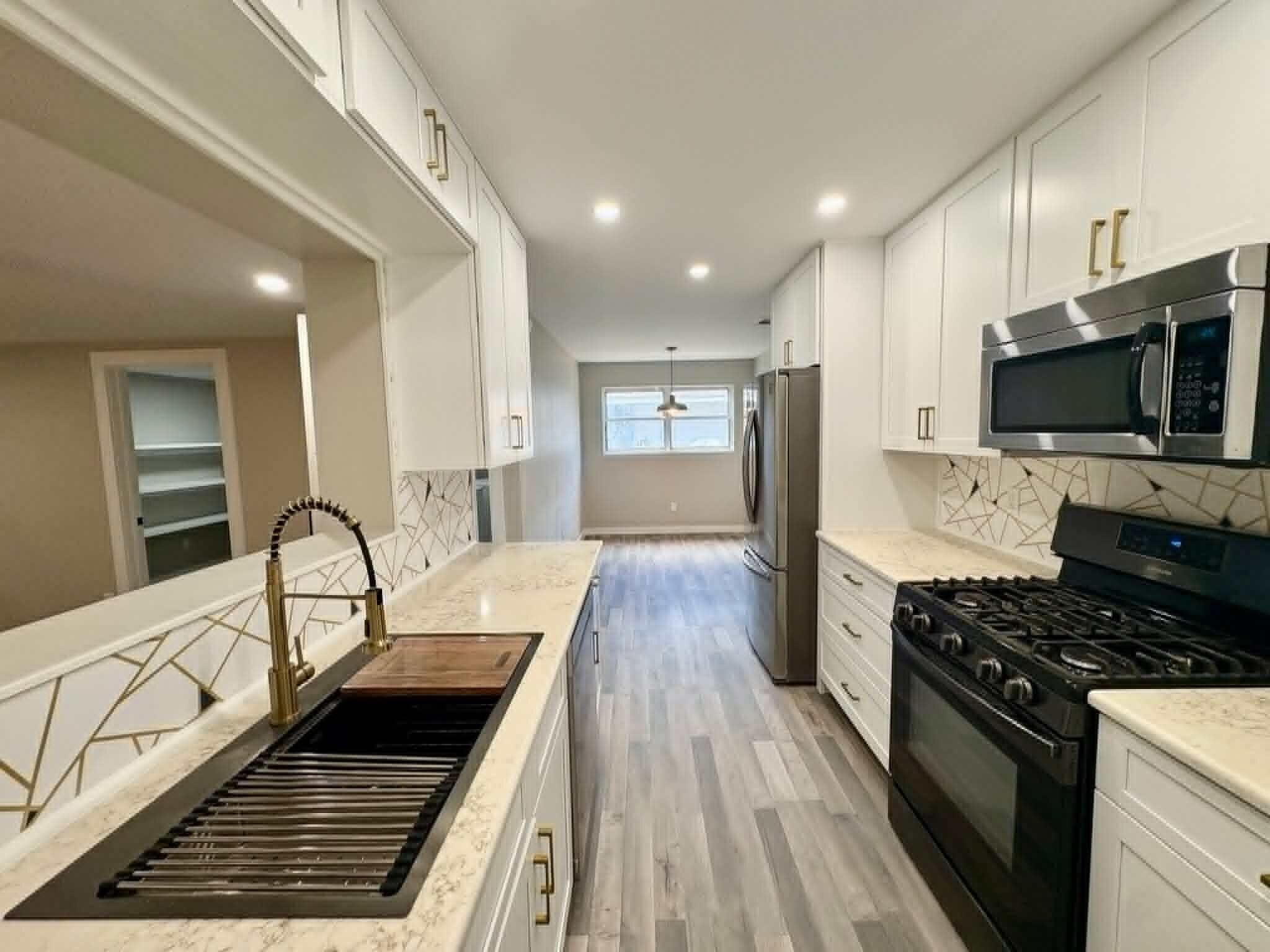 Expanded & Renovated From Top To Bottom

This 4-bedroom, 2-bathroom home was transformed from a 3/1 to now a monsterous  2,400 sqft of living space plus 620 SF of workshop that could remain that or possibly a guest room. Over $125K invested in premium upgrades. Open floor plan features 12mm luxury vinyl plank flooring, gourmet kitchen with 3cm granite countertops, travertine farmhouse sink, and custom soft-close cabinetry. Primary suite boasts barn doors with glass accents, dual closets, and spa-like bath with floor-to-ceiling tile, semi-frameless enclosure, and Schluter trim. Second bath completely upgraded with Red Gard waterproofing and cementitious backer board. NEW roof components, HVAC serviced with duct cleaning and antimicrobial treatment, all-new electrical devices and LED lighting, PEX plumbing throughout. Exterior features all-new deck, pressure-washed and painted siding, wood rot repairs, new shutters, fenced yard, and professional landscaping. Two outbuildings with steel doors, painted interiors. Near Eglin AFB, schools, beaches, shopping. Turnkey ready. MAJOR EXPANSION & RENOVATION - This home has been transformed from a 3-bedroom, 1-bathroom layout into a spacious 4-bedroom, 2-bathroom residence with approximately 2,400 heated square feet plus an additional 620 square feet of rear outbuilding space in desirable Fort Walton Beach! This move-in ready property offers modern coastal living with thoughtful updates throughout, luxury vinyl plank flooring (LVP) in all main living areas and wet areas, and a warm, welcoming atmosphere from the moment you enter.

The chef's kitchen features 3cm granite countertops with demi edge, white shaker-style RTA cabinetry with soft-close doors and drawers, black drop-in travertine sink with upgraded faucet assembly, trendy backsplash, and brand-new stainless steel appliances -- perfect for entertaining. The modified layout improves functionality with repositioned refrigerator, added panels, and overhead cabinet storage. Eye-catching designer wallpaper accents the wall above the cabinets for a polished, custom look.

The spacious living room centers around a gorgeous white brick fireplace with rich dark wood mantle, creating the perfect gathering space for movie nights and relaxation. Fresh paint, updated finishes, and abundant natural light enhance the clean, modern aesthetic.

Both spa-inspired bathrooms feature custom tile work with Schluter edge trim systems, cementitious backer board with waterproof membrane application (Red Gard), upgraded black plumbing fixtures, and modern LED lighting. The primary bathroom boasts a custom walk-in shower with prefabbed sloped shower pan, recessed wall niche, semi-frameless bypass glass shower enclosure with black hardware, and a shaker-style vanity with vessel sink. The secondary bathroom features a reglazed tub (like new), large shampoo niche, and granite countertop vanity. Both bathrooms include comfort-height toilets and exhaust fan/light combinations.

Major system upgrades include:

New electrical: Replaced all devices and wall plates, updated LED lighting fixtures throughout, new 4-inch recessed LED trims, and ceiling fans with integrated lighting in bedrooms
Plumbing upgrades: New water supply lines, refrigerator water supply line with shut-off valve, garbage disposal, and braided water supply lines for all appliances
Roofing repairs: New roof vent boots, fascia boards, flashing systems at rear addition with ice-and-water shield membrane, and peel-n-stick around chimney
HVAC servicing: Post-construction inspection, ductwork and evaporator coil cleaning with HEPA filtration, antimicrobial treatment, new air diffusers/registers, new digital thermostat, and new AC/Heat unit on rear porch with remote
Exterior restoration: Pressure washing, full interior and exterior paint systems (white and black), wood rot repairs, new soffit and fascia materials, new wood shutters, and new exterior trim packages
Interior finish upgrades include new pre-hung interior door units with black hardware package, new closet barn doors with glass accents, new primed square-stock baseboards and casing trim on all doors and windows, and custom closet shelving systems with hanging rods and bifold barn doors throughout -- including a custom 360° wrap walk-in pantry off the living room.

Outdoor living shines with a fully fenced private yard shaded by mature trees, refreshed deck with new pressure-treated deck boards, shored-up joists, ledger boards for water deflection, and new gate latches, locks, and hardware. The 620 square feet of rear outbuildings offer endless flexibility for hobbies, storage, or workshop space, with new steel entry doors, deadbolts, interior painted shelving, and all keyed to match the main residence.

Landscaping enhancements include tree and stump removal, hand grading, mowing, edging, two new 4x4 PT landscape boxes, new pine straw ground cover throughout front and back

Centrally located just minutes from Choctawhatchee Bay, beautiful Gulf beaches, local restaurants, and with Destin only 20 minutes away. This property captures the essence of ideal Florida living.
this home checks every box.