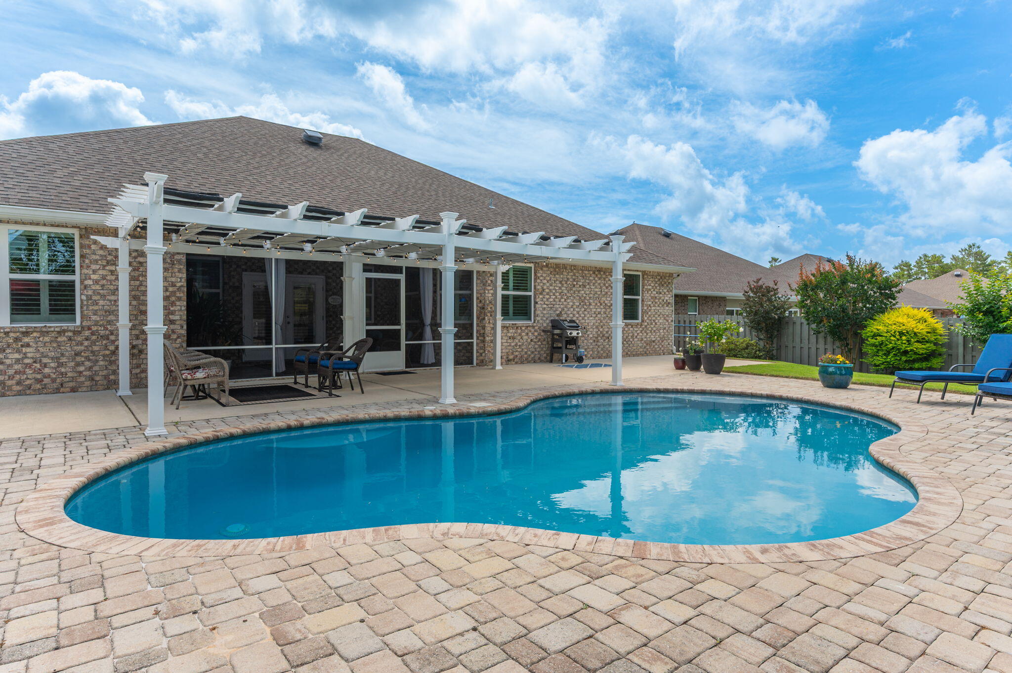 Welcome to 200 Sweet Tea Ln in the sought-after community of Hammock Bay, with resort-style living. This immaculate ranch-style residence offers the ideal blend of luxury, comfort, and functionality with 4 spacious bedrooms, 3 beautifully appointed baths, and an extraordinary backyard retreat with an enticing inground pool & pergola! This pristine home has been thoughtfully enhanced with high-end upgrades throughout. The heart of the home is the stunning, remodeled kitchen, featuring custom cabinet door and drawer fronts, sleek quartz countertops, an expanded quartz island, convenient slide-out drawers in the lower cabinetry, this space is as functional as it is beautiful. Adjacent dining and living areas create seamless flow, making the home feel both spacious and inviting. The luxurious primary suite serves as a peaceful sanctuary, offering generous space and a completely transformed spa-inspired bath. Relax and recharge in the spectacular oversized custom-tiled shower, complemented by a custom vanity with elegant quartz countertops and his & her large walk-in closets, and designer finishes that create a true retreat experience. Even the laundry room has received thoughtful upgrades with beautiful butcher block countertops, blending practicality with elevated design. Additional premium features include a whole-house Culligan water system and an epoxy-coated garage floor with built-in cabinets and ceiling storage racks, showcasing the meticulous care invested into every inch of this property.
Step outside and prepare to fall in love with your own private oasis. The screened-in back porch, with mounted television creates the perfect indoor-outdoor living experience for football Saturdays, relaxing evenings, or entertaining guests year-round. Beyond the porch lies a spectacular backyard retreat featuring a gorgeous inground pool, enticing pergola area, and fully fenced backyard designed for privacy, relaxation, and unforgettable gatherings under the Florida sun.
Living in Hammock Bay means enjoying one of the Emerald Coast's most amenity-rich communities. Residents have access to multiple resort-style pools, a state-of-the-art fitness center, pickleball and tennis courts, basketball courts, expansive playgrounds, scenic walking paths, and a beautiful clubhouse complete with a movie theater. This vibrant master-planned community offers a lifestyle that feels like vacation every single day while still being conveniently located near the beaches of 30A, shopping, dining, and top-rated schools.
Homes of this caliber--combining impeccable condition, luxurious upgrades, exceptional outdoor living, and premier community amenities--rarely become available. Whether you are searching for your forever home, a stunning second residence, or simply a place where every detail has already been perfected, 200 Sweet Tea Lane delivers an unparalleled living experience in one of Northwest Florida's most desirable communities.
This is more than a home, it is a lifestyle.