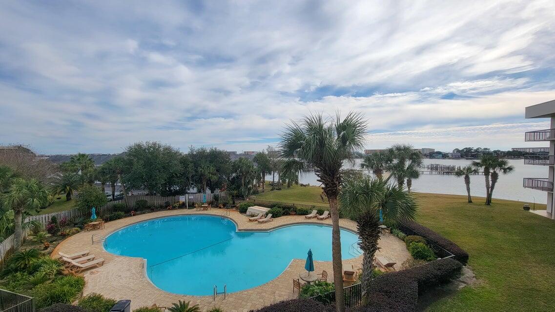 Welcome to effortless coastal living in this beautifully updated and fully furnished studio condo in Pirates Bay, complete with a deeded 40' boat slip (C9)! Located on the 3rd floor, this charming 325 sq ft unit offers breathtaking views of the Santa Rosa Sound and showcases high-end upgrades throughout.

Step inside to find wood-look ceramic tile flooring, quartzite countertops, and matching soft-close custom cabinetry that blends seamlessly across the kitchen, bathroom, and built-in office space. The handcrafted queen-size Bedder Way Murphy bed is painted to match the cabinetry, maximizing both style and functionality.