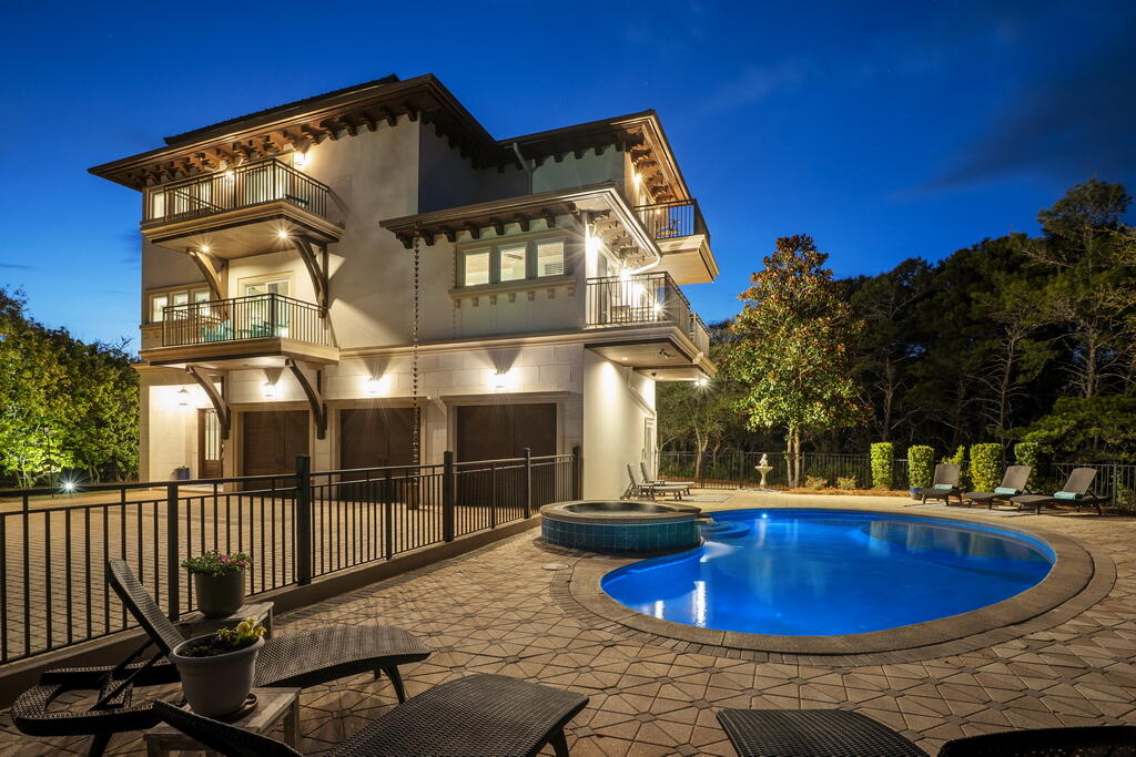 A lot of us crave the quiet beach getaway that made Old Florida legendary. It's harder to find since 30A has grown in popularity, but it can still be found if you know where to look. 278 Savelle Drive is an all-concrete constructed home located in Gulf Trace, a gated subdivision that's surrounded by the untouched beauty of Grayton Beach State Park. It has private beach access buffered by coastal dune lakes on either side providing an uncrowded beach for an HOA fee of only $1,000 annually. It combines that secluded feel with a location that's minutes from Grayton Beach, Seaside, and Watercolor. It's one of those rare subdivisions that offers the best of both worlds: easy access to all of the action along 30A, and privacy that makes you feel tucked miles away. 278 Savelle stands out among the homes of Gulf Trace with its prominent gulf views over the state park, all concrete block construction, home elevator, and true 3-car garage (nearly impossible to find south of 30A.) The pool area is uniquely large for 30A. It has a 30'x15' heated pool, 5'x5' spa with granite water feature, and over 1,400sq/ft of fenced-in pavered patio area surrounding it. Another thing that many 30A homes lack is adequate parking, but not 278 Savelle Drive. Along with the 3-car garage there's room for 8+ additional cars in the driveway. This home also has a sizable fenced-in backyard that borders the state park along with a 500+sq/ft covered patio equipped with a built-in outdoor kitchen. 

The home backs up to the state park which makes a great neighbor! The lack of buildings/development due to the state park means you can hear the waves crashing from the second floor balcony. I have really enjoyed sitting outside at this home and listening to all of the nature happening around me with birds chirping in the trees and squirrels chasing each other through the branches while the rhythm of breaking waves plays in the distance. This home has a uniquely peaceful atmosphere that stands out in my decade of selling real estate on 30A. The deer from the park seem to agree, we frequently see them grazing along 278 Savelle's fence line and sometimes even sleeping with their fawns underneath the magnolia tree in the backyard. 

When I think about 278 Savelle Drive the quality of construction stands out to me. It's all concrete block, and over 90% of homes in the area are not concrete. Of those that are, many choose to have concrete only on the first floor because it's an expensive building material. 278 Savelle Drive is all concrete, which benefits you in several ways. First, it means much lower insurance premiums (the owners currently pay $12,600 annually for homeowners insurance.) Second, it means that your utilities bills are lower due to the increased insulation and energy efficiency that concrete provides. Finally, it goes without saying that concrete construction is rated for higher winds and is a superior building material for withstanding storms when compared to the usual stick-frame construction that's common here on the Emerald Coast. Additionally, it has a home elevator that services all four levels, and it's smart home enabled with Control4 and surround sound. It also has whole home security cameras, a true 3-car garage, and every bedroom has its own ensuite bathroom and a private balcony (many of which have gulf views.)

The floor plan's flow is well thought out. Along the exterior is the three-car garage. It has access to three separate spaces: 1) the gunite-coated heated pool and spa 2) the 500sq/ft covered patio with built-in gas kitchen, 3) and the side door entrance to the home. There's also a full bathroom outside that serves as the pool bath. It makes it much easier to keep the house clean! It's a great place to shower off before throwing your sandy bathing suits into the first-floor laundry after a beach day. Finally, there's a lockable 12'x8' storage room with sturdy shelving and Control4 activated lights for easy storage of all things outdoors. 

The first floor is designed to be a large mudroom and ideal landing area. It has the walk-in laundry room, home elevator, and a storage closet under the stairs that also serves as the audio/video hub for the smart home and Control4 features. The stairwell has floor-to-ceiling windows on all levels, so as you ascend in the home you get increasingly beautiful views of the state park and the Gulf of America. 

The second floor hosts the main living area and also three guest bedrooms each with their own ensuite full bath and private balcony. The centerpiece of the second story is the living room with its combination of shiplapped and wainscoted walls that rise up to an impressive 28' apex. It has an ample number of windows that usher natural light into the space and provide views of the Gulf and state park. It's also crowned with one of the most unique features I've ever seen in a home. Hanging from the ceiling is a life boat that's been converted into a light fixture. This isn't just some decorative piece, it's an actual life boat that saved a man from a shipwreck, and he would only sell it to the builder on condition that he preserve it and do something cool with it. I'd say the builder held up his end of the bargain. 

The kitchen has a large island topped with polished granite, an ideal natural stone due to its resistance to stains (superior to marble in that aspect) and its durability. The bar has seating for up to six people and the nearby dining room table has seating for ten. The kitchen also has a 60" Wolf range with six burners and a griddle, custom cabinetry with dovetail joints (the gold standard of construction for cabinetry), stainless steel refrigerator, wine cooler, dual dishwashers, and an extra wide stainless steel sink. It's framed in by lighting mounted under the cabinets and a myriad of custom wood finishes. There's also a half bath located directly off the living room and kitchen area, so a guest never has to intrude by going through a bedroom to get to a bathroom.

Also off the main living area is the second floor balcony which spans the length of the home and provides enough space for even a large group to sit or dine comfortably. This is one of my favorite spaces in the house. I can hear the waves rolling onto shore in the distance while birds chirp in the trees of the state park. It faces Southwest, ideal for Summer sunsets. It makes for a perfect indoor/outdoor entertainment setup with its convenient location directly off the kitchen and living room.

On the third floor the primary suite, a large home office with a built-in wet bar and gulf views, as well as an additional guest bedroom. The primary suite has its own wet bar complete with a refrigerator and ice maker. It's a cool hidden feature since it's paneled to look like cabinetry. The space also has a custom designed closet, a private balcony with gulf views, and a large ensuite bathroom. The primary bath has a massive walk-in shower complete with dual showerheads and an additional rain-style showerhead. It also has a bathtub, a full body length wall-mounted mirror, and his-and-hers style separate vanities.

The fourth floor, or the penthouse suite as it's lovingly referred to, is the newest addition to the home. It was added in 2017 to further capture the views across the state park, and it also gets excellent sunsets (particularly in the Summer.) It has a king sized bed, private wet bar, ensuite bath with dual vanities and walk-in shower, and it's accessible by elevator.

278 Savelle Drive is located in the gated neighborhood of Gulf Trace. It boasts private beach access and it's surrounded on all sides by Grayton Beach State Park. It's less than 3 miles from Seaside, Watercolor, and Grayton Beach but due to the state park it feels natural, secluded, and private. It's the perfect location for the discerning buyer who wants to be in the middle of the action on 30A but also have a quiet haven to retreat to when they're ready to relax, all for an HOA fee of only $1,000 annually.