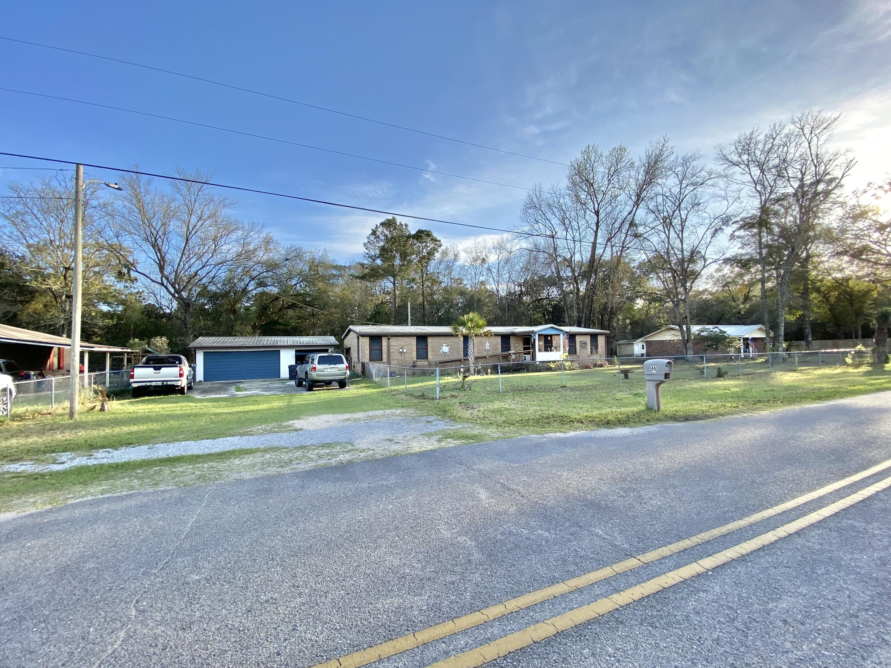 SPACIOUS 4 LOT PARCEL with a larger double wide mobile home located in a charming community just off of Bay loop Rd. Just minutes to downtown Freeport, Freeport Regional Sports Complex at Hammock Bay, Shipyard Boat Ramp (AKA Four Mile Point Public Boat Launch), and Freeport Marina and Yacht Club! This home offers ALL BRICK SIDING, 3 bedrooms/ 2 bath large floor plan, separate living and family room, formal dining room, a Florida room, and a completely fenced in yard providing ample privacy. RV, BOAT or both you have the space for your toys! 2 CAR DETACHED GARAGE made of concrete block with 2 shed or workshop areas. METAL ROOF 2020, all-inclusive AC/Heater combo just a year old and newer water heater. With its proximity to the Beach and ample parking could be a great short-term rental! Does need TLC like flooring, inside paint but with that can be fresh and new! You can really have the best of both worlds; quiet and seclusion yet just a short drive to all the action (beaches, shopping, dining, and entertainment) of the emerald coast. Buyer and buyers agent to verify all dimensions and anything deemed important.