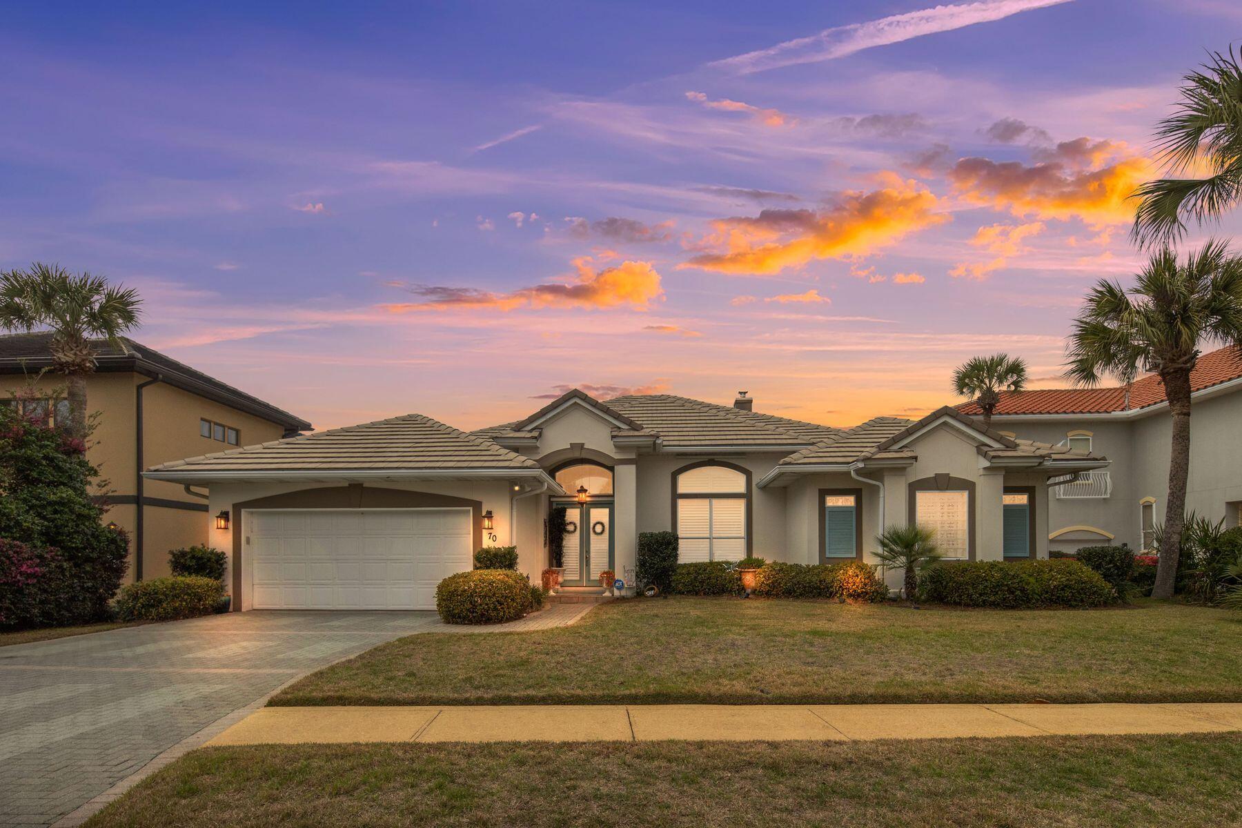 Tucked along a quiet cul de sac south of Highway 98 and just moments from the sugar white sands of the Emerald Coast, 70 Siesta Bluff presents an exceptional opportunity to enjoy the relaxed elegance of coastal living within the gated community of Destiny East. Approximately 1,000 feet from the gulf, this beautifully maintained Mediterranean residence offers a rare blend of privacy, spacious single level living, and timeless design in one of Destin's most sought after locations.

Spanning approximately 3,192 square feet, the home features four bedrooms and four bathrooms thoughtfully arranged for both comfort and functionality. Lovingly cared for as a second residence and never utilized as a short term rental, the property showcases pride of ownership throughout while still offering excellent potential as an investment or vacation home.

Designed with entertaining and everyday living in mind, the main living areas flow seamlessly together. The spacious living room opens into a formal dining space, creating an inviting atmosphere for hosting family and guests. At the center of the home, the recently updated chef's kitchen combines style and performance with granite countertops, generous cabinetry, an oversized island, and a premium appliance package that includes a Wolf cooktop, Wolf double ovens, Wolf dishwasher, Sub Zero wine refrigerator, and GE Monogram refrigerator.

The primary suite serves as a peaceful private retreat with direct access to the outdoor living area and  pool terrace. The ensuite bath features dual vanities, a jetted soaking tub, and a spacious walk in shower. Three additional guest bedrooms provide comfortable accommodations for visitors, including guest suites with private baths and a fourth bedroom with convenient access to the pool area.

Outdoor living is equally impressive. The fenced backyard is centered around a beautifully refreshed gunite saltwater pool with recently updated gunite, surrounded by mature landscaping that creates a tranquil setting for relaxing or entertaining. Inside, a gas fireplace adds warmth and character to the main living space, while practical features such as an oversized two car garage, expansive laundry and mudroom, whole home hurricane shutters, upgraded HVAC systems, and added attic insulation further enhance the home's comfort and functionality.

Additional recent improvements include fresh interior and exterior paint completed in 2022, along with roof paint and a roof certification completed in December 2025 confirming an additional five years of life, with documentation available.

Residents of Destiny East enjoy access to an impressive collection of amenities including a clubhouse with fitness center, resort style pools, pickleball and basketball courts, playground, grilling areas, lake access, and golf cart friendly streets connecting you to nearby dining, shopping, entertainment, and Destin's renowned beaches.

Offering refined coastal living in an ideal location near the gulf, 70 Siesta Bluff is perfectly suited as a primary residence, luxury second home, or future investment opportunity along one of Destin's most desirable beachside corridors.