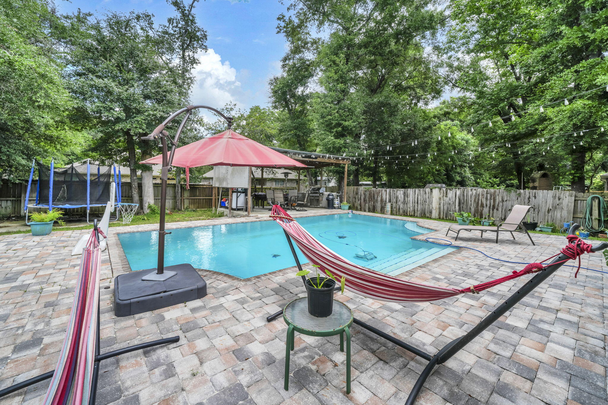This modern Craftsman-style 4-bedroom, 2-bath home with a beautiful inground heated pool sits on .41 acres in the heart of Niceville. Meticulously maintained, this all-brick residence features a welcoming front porch, screened back porch, split floor plan, walk-in closets, quartz countertops, custom soft-close shaker-style all-wood cabinets, slate-finish GE appliances, a walk-in pantry, and an oversized island with breakfast bar.
The open-concept layout is enhanced by luxury vinyl plank flooring in the bedrooms and ceramic tile throughout the living room, kitchen, and dining area. Located in a quiet neighborhood, the home also offers a spacious backyard rarely found in the area, a beautiful heated pool, EV charger, epoxy-coated garage and front porch floors. This home is ready for your family to create lasting summer memories with its spacious backyard and beautiful heated pool! Conveniently located in an A+ School district and close to the beaches of Destin, Eglin AFB and 7th Group.