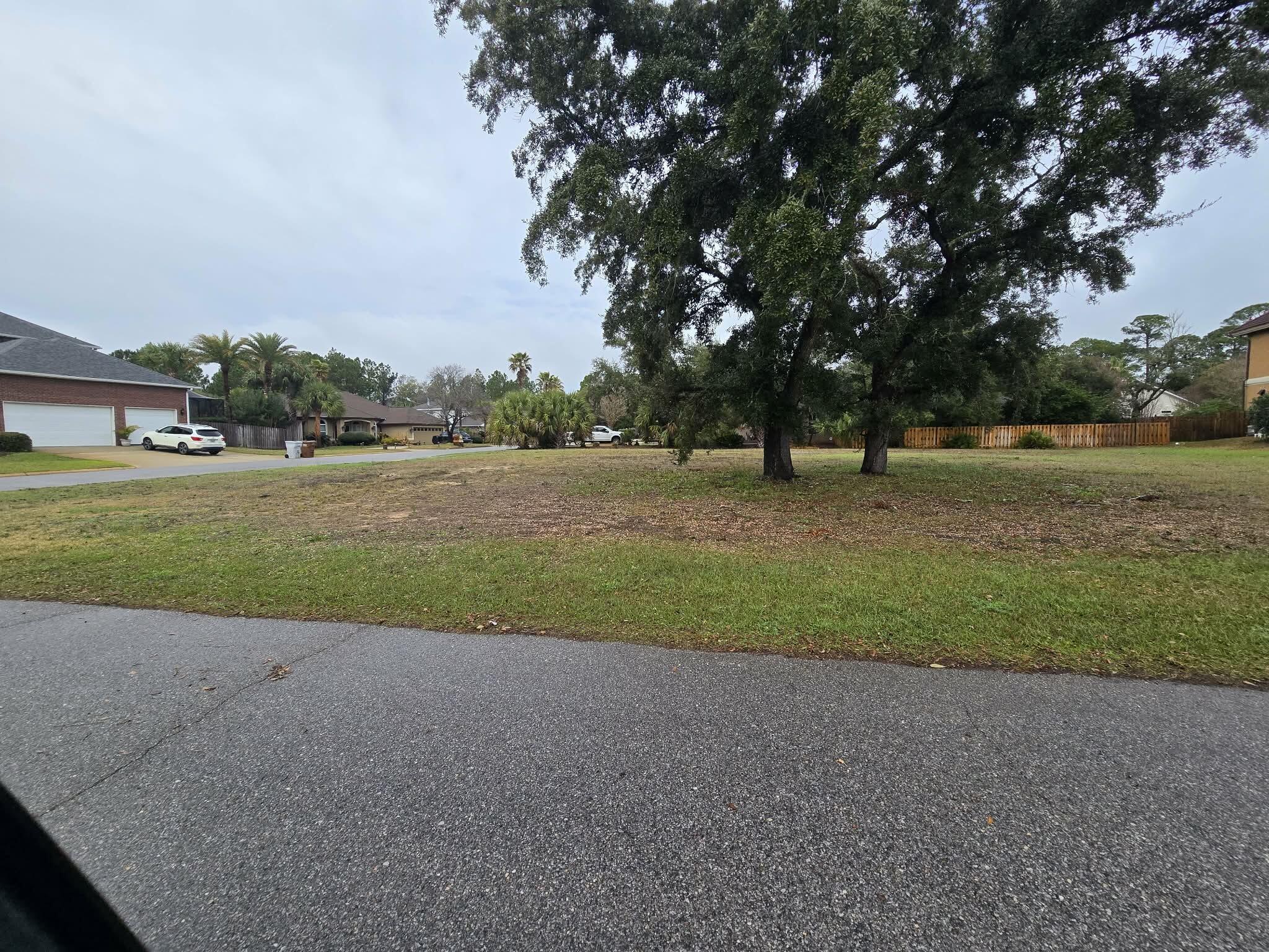 Build your dream home in the highly sought-after Tiger Point Village community in Gulf Breeze, Florida. This cleared lot is ready for construction and offers beautiful water views with desirable southern exposure, nestled among many high-value homes in one of the area's most desirable golf course neighborhoods. Located on coveted Madura Road near the Madura Four Curve, the property sits among several stunning homes and is surrounded with lush landscaping and coastal charm.

Just across the street from the Santa Rosa Sound and close distance from the Soundside Foundation Nature Preserve, residents enjoy easy access to scenic walking and hiking trails as well as a peaceful beach area along the sound. The neighborhood is known for its quiet, golf-oriented atmosphere, golf cart-friendly streets, and proximity to the Tiger Point Golf & Country Club and The Pointe Restaurant.

Convenience meets coastal living with nearby shopping, dining, and everyday essentials including Publix, Lowe's, Walmart, fitness centers, and more all within approximately one mile. Highly rated local schools include Oriole Beach Elementary, Gulf Breeze Middle, and Gulf Breeze High School. A world-class healthcare facility located at the entrance of Tiger Point East provides convenient access to urgent care, primary care, imaging, and physical therapy services.

Enjoy the best of the Emerald Coast lifestyle with Pensacola Beach just 10-15 minutes away and Navarre Beach approximately 14 miles to the east. With only a limited number of vacant homesites remaining in this desirable community, this is a rare opportunity to secure a premier lot and build your custom coastal home in one of Gulf Breeze's most established and scenic neighborhoods.