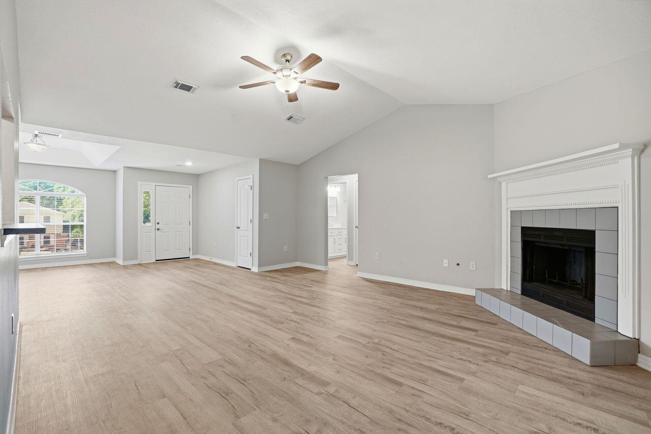 Once inside the front door, this home features all new and neutral laminate flooring throughout. To the 
right is a designated dining area that offers space for all your family gatherings which is open to the living 
room and features a warm cozy fireplace. Beyond the living room to the right is the kitchen with new 
granite counter tops, newly painted cabinetry and an eat-in area with bay windows. The master bathroom features a new vanity with double sinks, subway tile backsplash, and a tub/shower combo. To complete the  master bedroom is a  large walk in closet. The guest bedrooms are located on the other side of the home and are separated by a guest bath. Also adding to the appeal of this home is nearly everything on the 
interior has been replaced. New stove & refrigerator, new flooring throughout, fresh new paint throughout, all new 
lighting fixtures, all new outlet receptacles, all new light switches, new electrical panel, new vanities and 
fixtures, new counter tops, and new door knobs. The seller has had the septic pumped and inspected 
along with a fireplace inspection and new fire box installed. This home sits on .40 acre giving you plenty of outside space also. Roof - 2021, HVAC - 2022, Water Heater - 2016.  Don't miss this one!