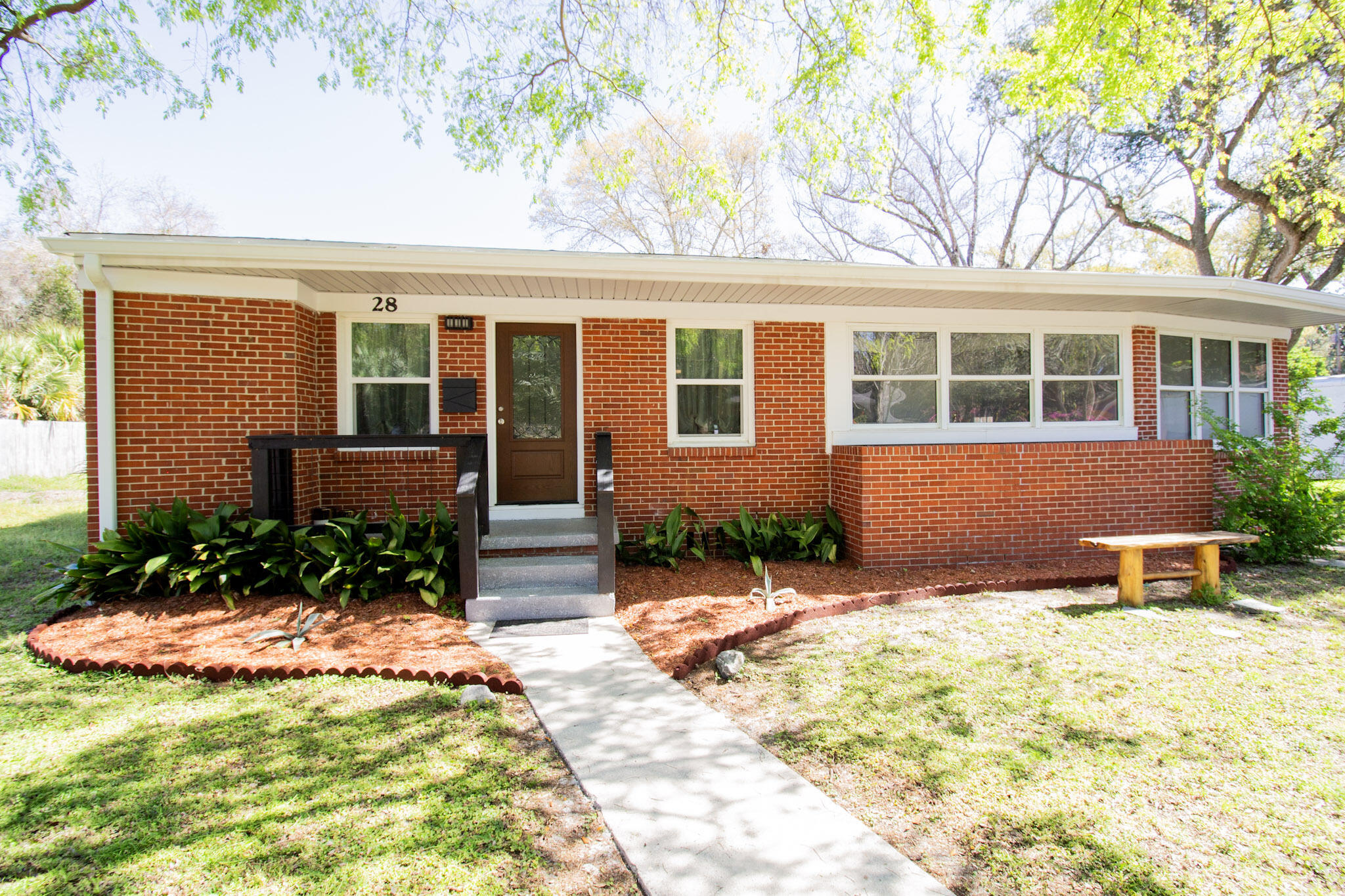 Updated Brick Cottage in Gulf Breeze Proper! This 3 bed, 2 bathroom brick cottage has been newly remodeled with modern updates. The kitchen has been fully renovated with custom cabinetry, tile backsplash, stainless steel appliances, and a pass-through window to the dining area. Enjoy two living spaces with the open-concept front living room and a spacious second living area on the opposite side of the home. The master bathroom features a quartz countertop vanity, new mirrors and lighting, and a tiled shower with a frosted glass door. The second bathroom includes a quartz vanity with a vessel sink, a freestanding tub/shower combo, and updated lighting. Impact-resistant windows bring in natural light, and the utility room offers storage above the brand-new water heater and washer/dryer area Additional upgrades include LVP flooring, fresh paint, a new roof (2022), complete rewire (2023), new HVAC (2023), and a vapor barrier with insulation in the crawl space (2024). The large lot offers mature landscaping and plenty of outdoor space. This home has it all and is priced to sell! Call today for your private showing.