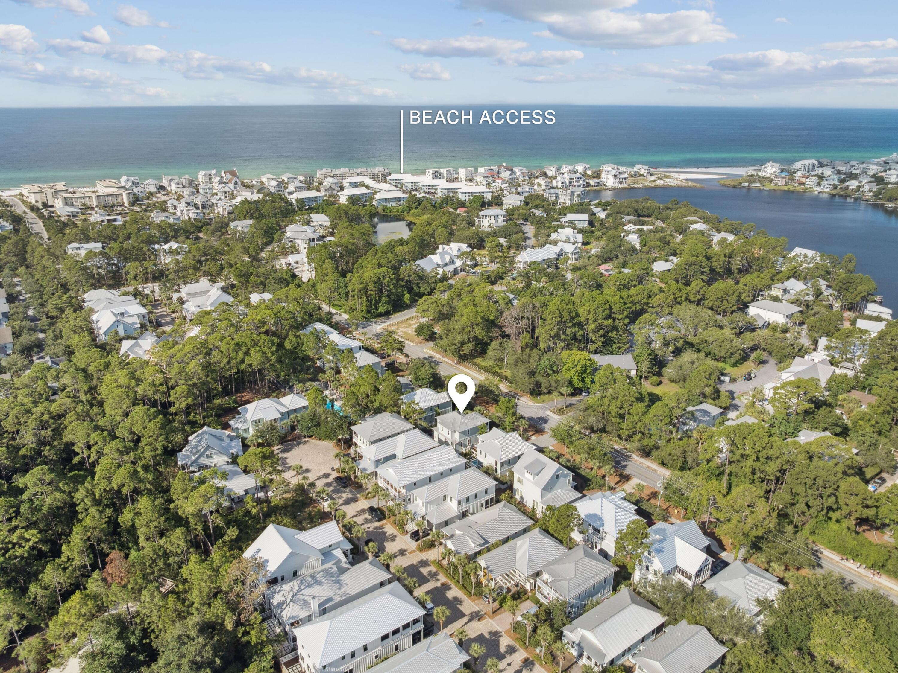 This inviting coastal cottage offers the quintessential beach lifestyle just steps from Eastern Lake and minutes from sugar-white sands. Spanning 2,067 square feet of heated and cooled living space, plus an additional 240 square feet of porches, this home provides ample room for relaxed gatherings and quiet retreats alike. Inside, an open-concept first floor welcomes with 10-foot ceilings, hardwood and travertine flooring, and a thoughtfully updated kitchen outfitted with stainless steel appliances and gleaming white Carrara marble counters. Remote-controlled thermostats add modern convenience.