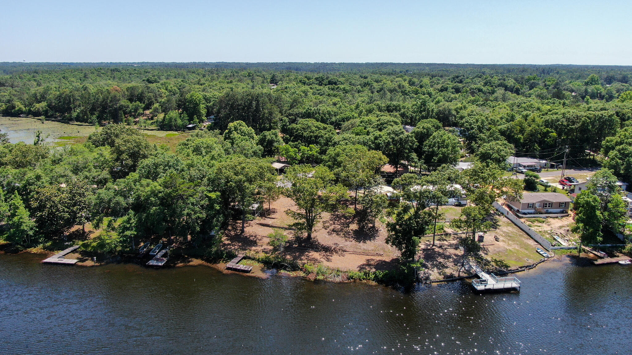 Two beautiful waterfront lots on Juniper Lake  with nearly 1/2 an acre.  Lots are mostly cleared, with a dock and a shed that could be made into a little fishing camp. There is also a septic tank, condition unknown. Create your fishing camp or permanent residence! Nice, gentle slope down to the water. Juniper Lake offers an abundance of bass, bream and crappie. Water tap fees are paid.