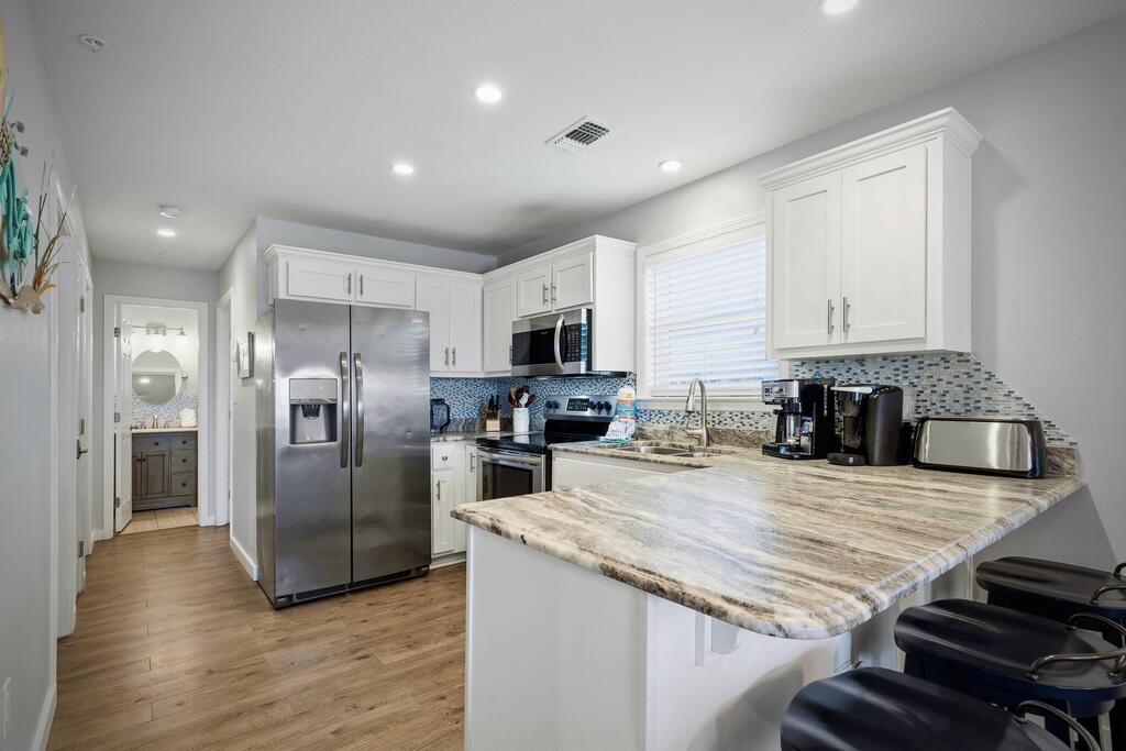 Luxury updates, deeded beach access and superb Destin Florida location. Those three things are what you can feel when you stay in unit 433 in St. Martin Beachwalk. My favorite feature is how peaceful I feel sitting on the private balcony relaxing and overlooking the sparkling pool, and as I breathe in the fresh salty air blowing in from the Gulf. I love how you notice that you are just steps from the pool, and just a few minutes walk from the St. Martin Beachwalk deeded Destin beach access.

Every luxury aspect of this beach property was chosen with intention. Since the owners purchased it, they have had it professionally decorated, added Luxury Vinyl Plank flooring, shutters, updated the living room furniture and accessories, fully updated the kitchen with granite countertops, backsplash, painted the cabinets white, added stainless steel appliances and bar stools. They didn't stop there either! They updated the three bedrooms with new furniture and accessories, plus they updated the master bathroom and the guest bathroom too! Just beautiful!

Upon entering the property I'm immediately struck by two things: The quality and care which has been taken to keep this property in excellent condition, and the peace and comfort I feel in this amazing beach property.

Whether you are looking for a short term rental investment property, which produces great, or a fabulous beach vacation property for yourself, unit 433 in St Martin Beachwalk provides it all!

St. Martin Beachwalk is located in the heart of Destin Florida and is just minutes from delicious dining featuring fresh Gulf of America seafood, an abundance of shopping choices, Big Kahuna's Water Park, Crab Island, the famous Destin Harbor, and the Gulfarium Marine Water Park! Plus the cherry on top is you just walk a few minutes from the condo to your own St. Martin Beachwalk deeded Destin Beach access. It truly is a beach paradise!