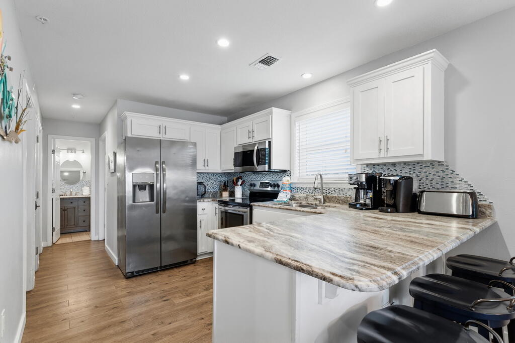Luxury updates, deeded beach access and superb Destin Florida location. Those three things are what you can feel when you stay in unit 433 in St. Martin Beachwalk. My favorite feature is how peaceful I feel sitting on the private balcony relaxing and overlooking the sparkling pool, and as I breathe in the fresh salty air blowing in from the Gulf. I love how you notice that you are just steps from the pool, and just a few minutes walk from the St. Martin Beachwalk deeded Destin beach access.

Every luxury aspect of this beach property was chosen with intention. Since the owners purchased it, they have had it professionally decorated, added Luxury Vinyl Plank flooring, shutters, updated the living room furniture and accessories, fully updated the kitchen with granite countertops, backsplash, painted the cabinets white, added stainless steel appliances and bar stools. They didn't stop there either! They updated the three bedrooms with new furniture and accessories, plus they updated the master bathroom and the guest bathroom too! Just beautiful!

Upon entering the property I'm immediately struck by two things: The quality and care which has been taken to keep this property in excellent condition, and the peace and comfort I feel in this amazing beach property.

Whether you are looking for a short term rental investment property, which produces great, or a fabulous beach vacation property for yourself, unit 433 in St Martin Beachwalk provides it all!

St. Martin Beachwalk is located in the heart of Destin Florida and is just minutes from delicious dining featuring fresh Gulf of America seafood, an abundance of shopping choices, Big Kahuna's Water Park, Crab Island, the famous Destin Harbor, and the Gulfarium Marine Water Park! Plus the cherry on top is you just walk a few minutes from the condo to your own St. Martin Beachwalk deeded Destin Beach access. It truly is a beach paradise!