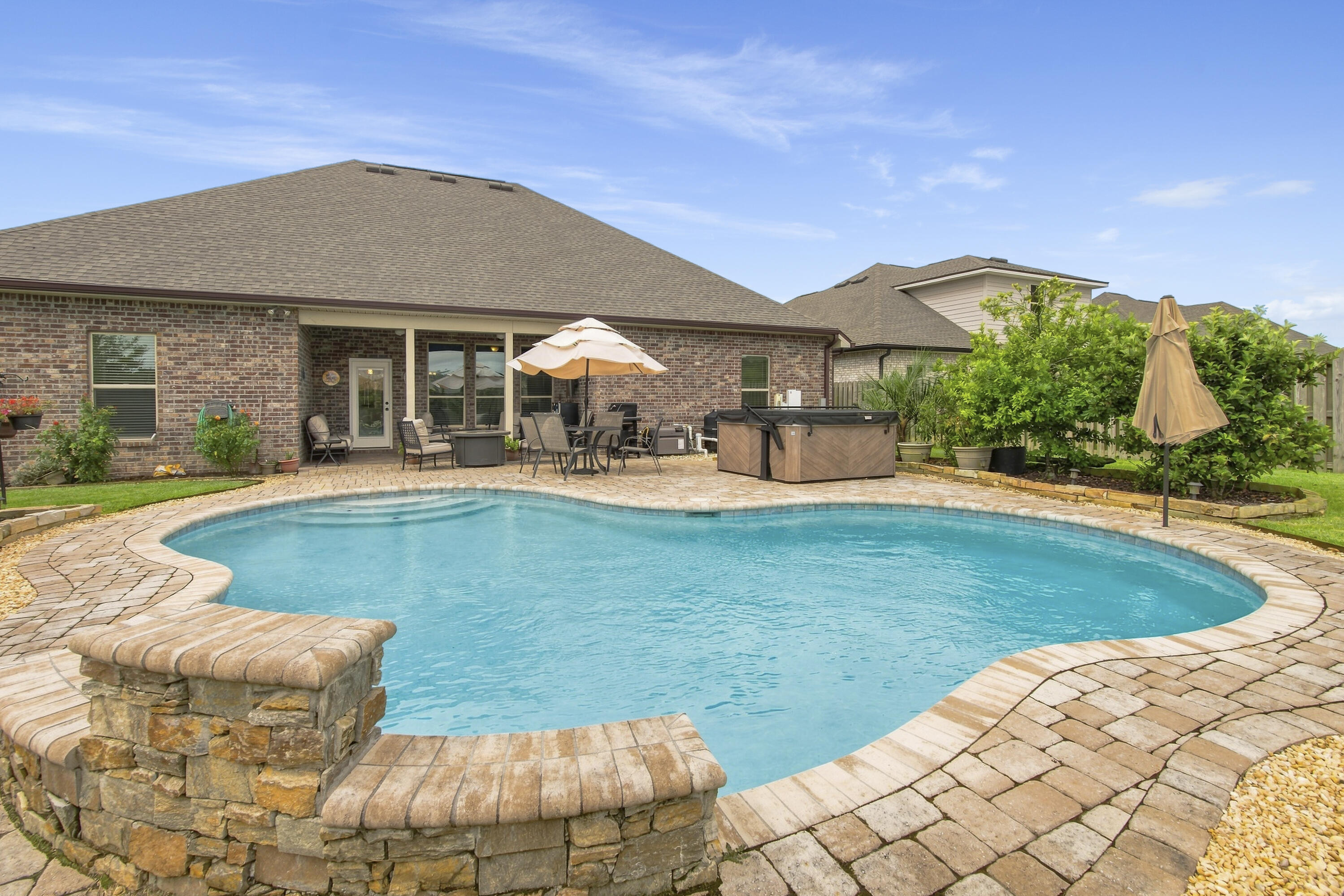 Imagine coming home to your own private backyard resort. The centerpiece of this exceptional Hammock Bay home is a spectacular heated in-ground pool with a cascading waterfall and LED Lights, surrounded by an expansive paver brick patio, lush professional landscaping, and a privacy-fenced backyard that creates the perfect setting for entertaining, relaxing, or enjoying Florida's beautiful weather year-round.

Inside, this beautifully appointed 4-bedroom, 3-bath home offers more than 2,700 square feet of thoughtfully designed living space. The open-concept floor plan is enhanced by elegant wood-look tile flooring, quartz countertops, Large Walk-In Pantry, a Gas Range for the home chef and a warm Gas Fireplace that brings family and friends together. A Formal Dining invites Family and Guests to gather for Holiday Meals. Crown Molding throughout home. This home is complete w a built-in separate Office Space, a HUGE Primary Closet that conveniently connects to the Laundry Room!  The Garage Entry has extra Storage and Boot Bench  A whole-house Generac generator provides added peace of mind and dependable backup power when you need it most.
Located in the highly sought-after Hammock Bay community in Freeport, you'll enjoy outstanding neighborhood amenities: Pickleball, tennis, bball, Exercise Room and Exercise Classes, 3 Pools, Props Brewery, General Store, Monthly Farmers Markets, and Holiday Events year-round from 4th of July  Bike/Golf Cart Parade to Santa's visit at the Town Center Pavilion. 
All while being just minutes from shopping, dining, THE top-rated schools, and the Emerald Coast's world-famous Sugar white-sand beaches.Whether you're hosting unforgettable poolside gatherings or enjoying a quiet evening by the fire, 303 Blaze Boulevard offers the perfect blend of luxury, comfort, and the Florida lifestyle you've been searching for and the Florida lifestyle you've been searching for. 
Welcome HOME!! 
This Home is priced to sell and Sellers are offering a $8000 Credit toward Closing Costs