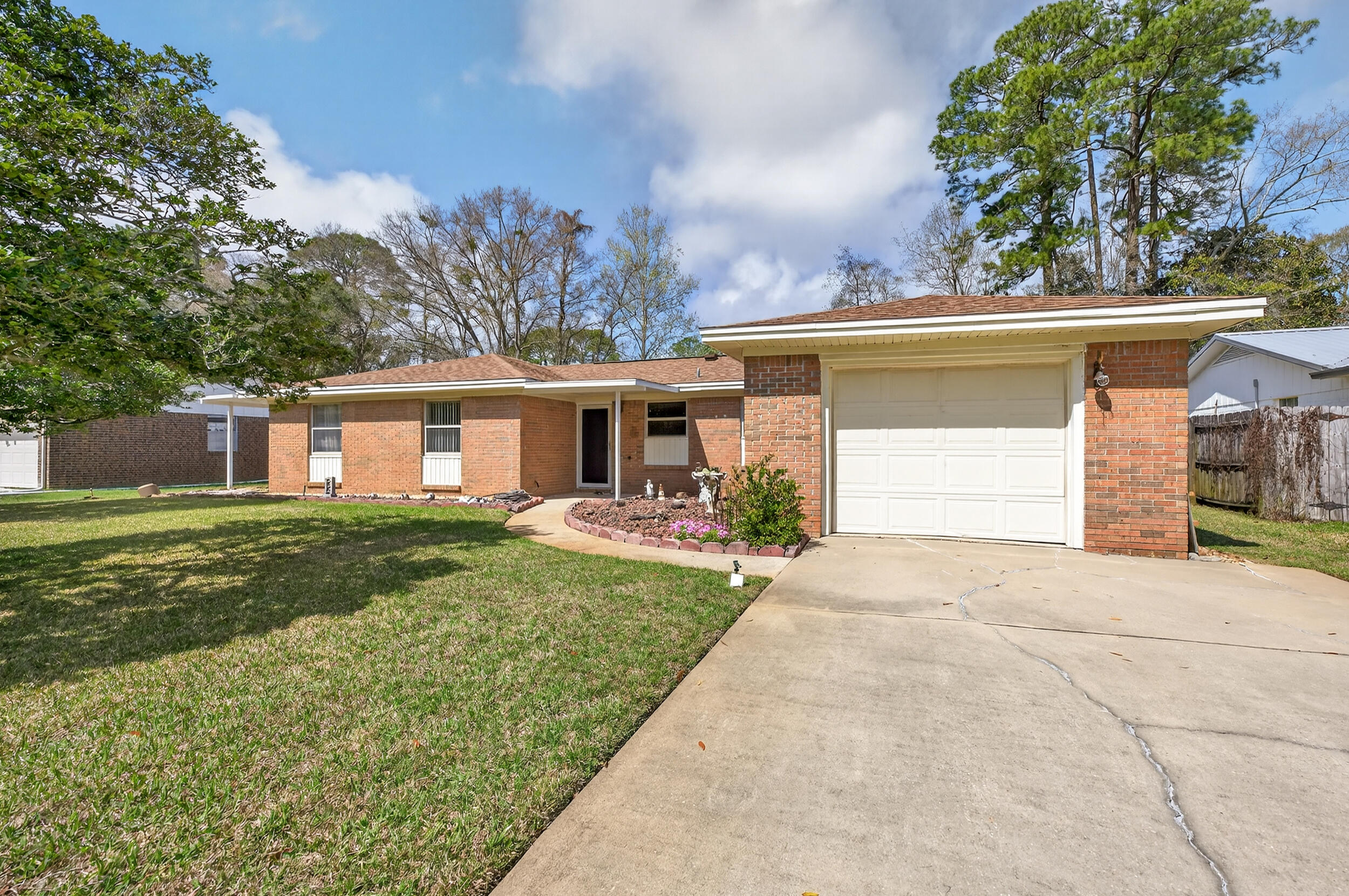 Located in the heart of Niceville, this charming 3-bedroom, 2-bath home offers comfort, thoughtful updates, and a convenient central location. Seller will replace the roof prior to closing, providing added peace of mind for the new owner. Inside, the home has a warm, cozy feel with wood laminate flooring in the living room and hallway and a spacious layout that includes a large dining room that could also serve as a flex space for an office, playroom, or second living area. The kitchen has been updated with gray cabinets, granite countertops, tile flooring, and newer white appliances including a gas range. Both bathrooms feature updated cabinets, granite countertops, and newer fixtures. Major systems include a 2007 gas tankless water heater and a 2014 HVAC system. The bedrooms are carpeted and the flooring will need to be replaced, giving buyers the opportunity to personalize the space. All of the windows were updated with Hurricane rated windows. 

Outside, enjoy a large covered back porch overlooking a well-maintained yard with St. Augustine grass and mature persimmon fruit trees, and pear trees. A portable storage shed provides additional space for tools or lawn equipment. Conveniently located near schools, parks, shopping, and Eglin Air Force Base, this home offers a great opportunity to enjoy life in the heart of Niceville.