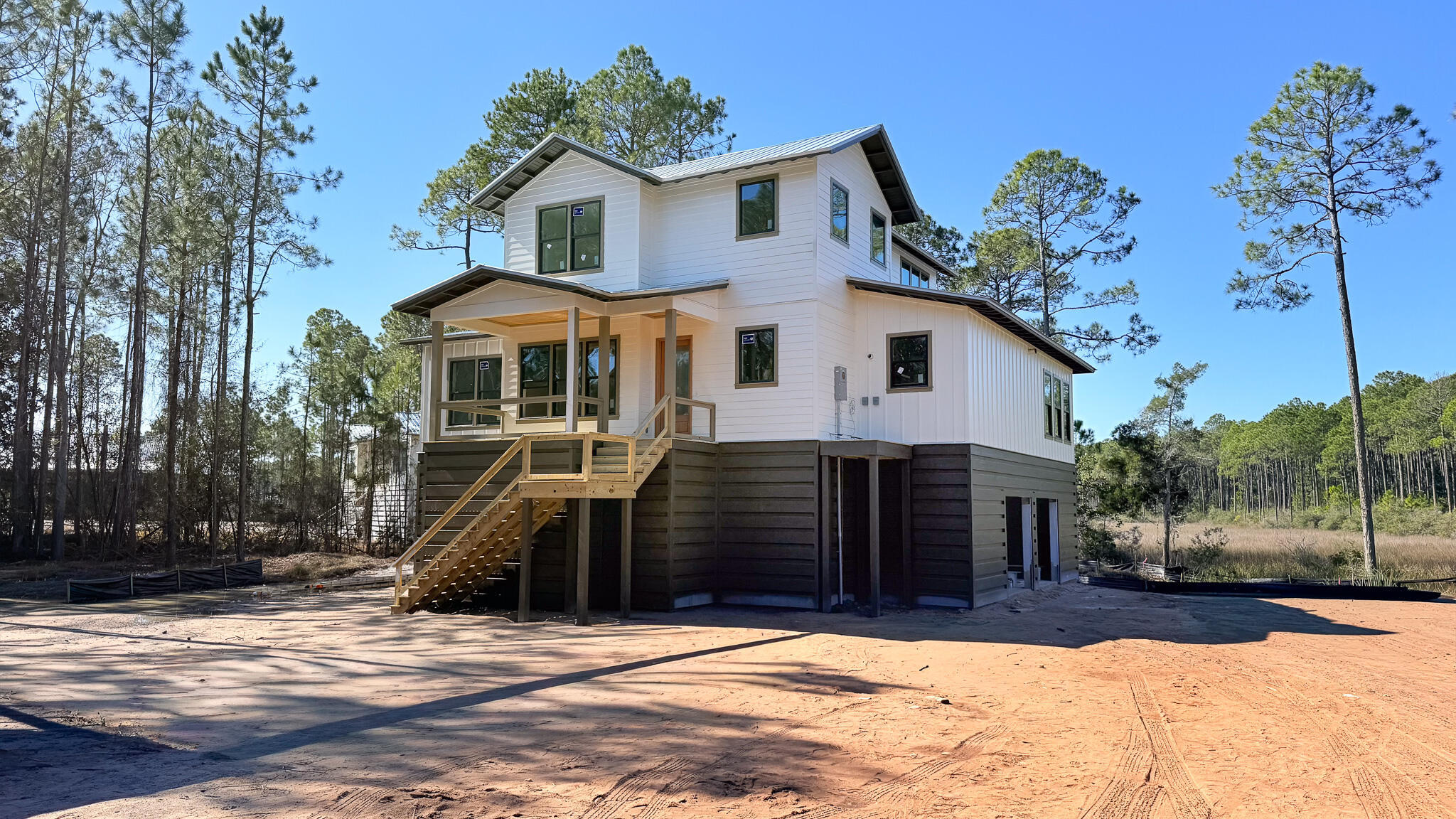 Experience modern coastal living in this newly built 3‑bedroom, 3.5‑bath custom home. This new construction property features a thoughtfully designed floor plan, contemporary finishes, and scenic water views. Located within the gated community of RiverCamps, residents enjoy extensive amenities including a boat launch, boat storage, fishing docks, community canoes, community pool, pickleball courts, a basketball court, walking trails, and convenient community facilities for guests. This home offers excellent proximity to Northwest Florida Beaches International Airport (ECP) and the area's new hospital, making it ideal for full‑time residents or those seeking a newly built home. Constructed by CNC Homes, a reputable local builder, this property blends craftsmanship, location, and lifestyle.
