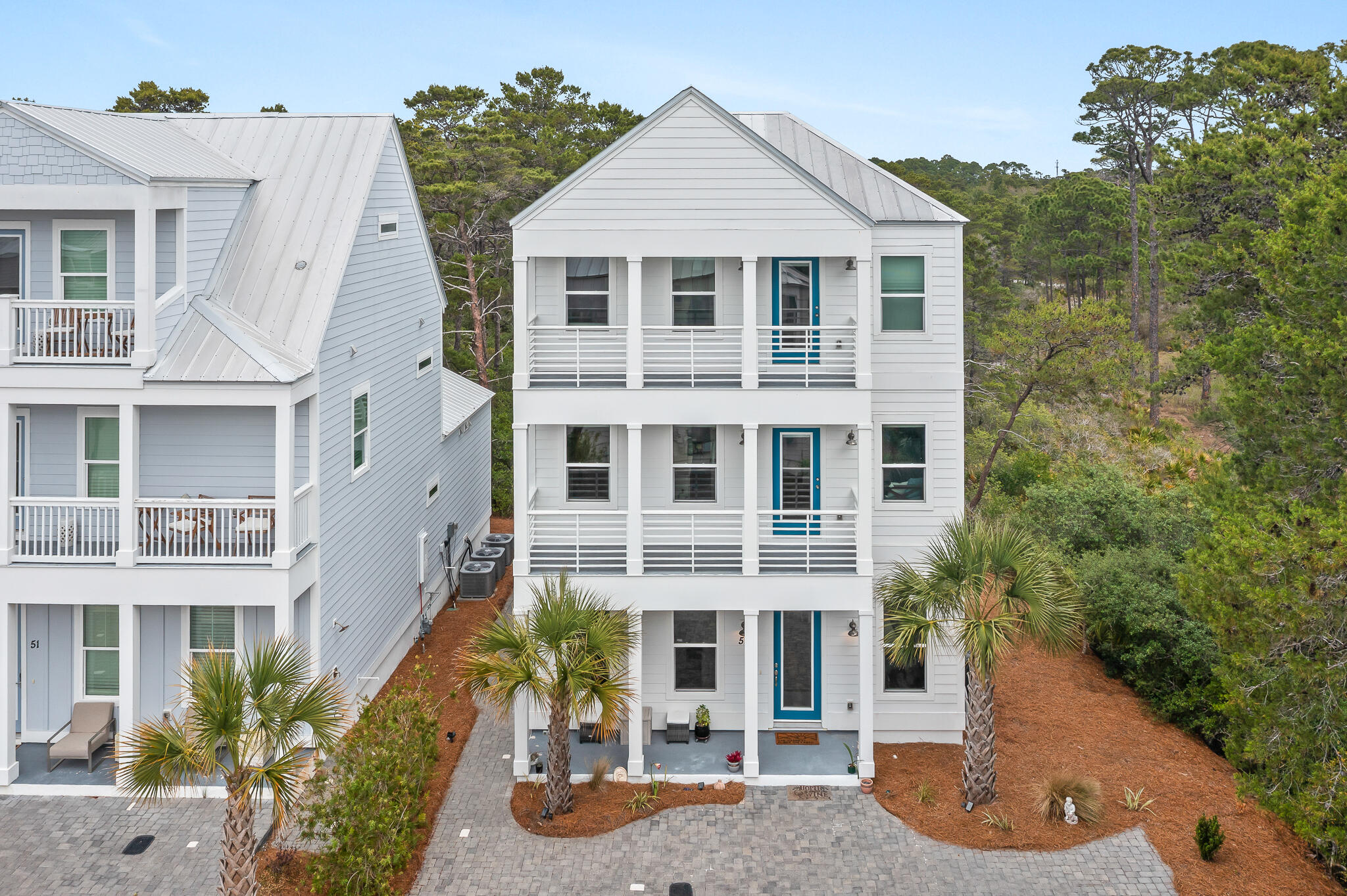 Set on a premium homesite in the northeast corner of Serenity at Dune Allen, this beautifully maintained three-story residence offers a rare sense of privacy along 30A's west end. Green space borders the home to the north and east, creating a quiet natural backdrop that distinguishes the property from others in the community while placing the beach within easy walking distance.

Never rented and presented in like-new condition, this four-bedroom, four-and-a-half-bath home is designed with comfort, flexibility and effortless coastal living in mind. Over 1100 sq. ft. in exterior porch spaces plus extended parking provides a valuable advantage for owners and guests, while the versatile layout supports use as a primary residence, second home or future rental investment. The main living level is bright and inviting, with raised ceilings, abundant natural light and an open-concept design that connects the chef's kitchen, dining and gathering spaces with ease. Modern finishes lend a polished coastal feel, while multiple porches across all three levels invite quiet mornings, afternoon breezes and relaxed evenings outdoors.

All four bedrooms feature ensuite baths and private porch access, offering a thoughtful level of comfort for family and guests. The second and third levels each include two spacious bedroom suites along with flex nooks suited for a home office, reading area or secondary lounge space. A screened rear patio expands the outdoor living experience, providing another shaded place to enjoy the home's peaceful setting.

With a community pool, beach access nearby and one of the more desirable homesites in Serenity at Dune Allen, this home pairs convenience with privacy in a location made for the 30A lifestyle.