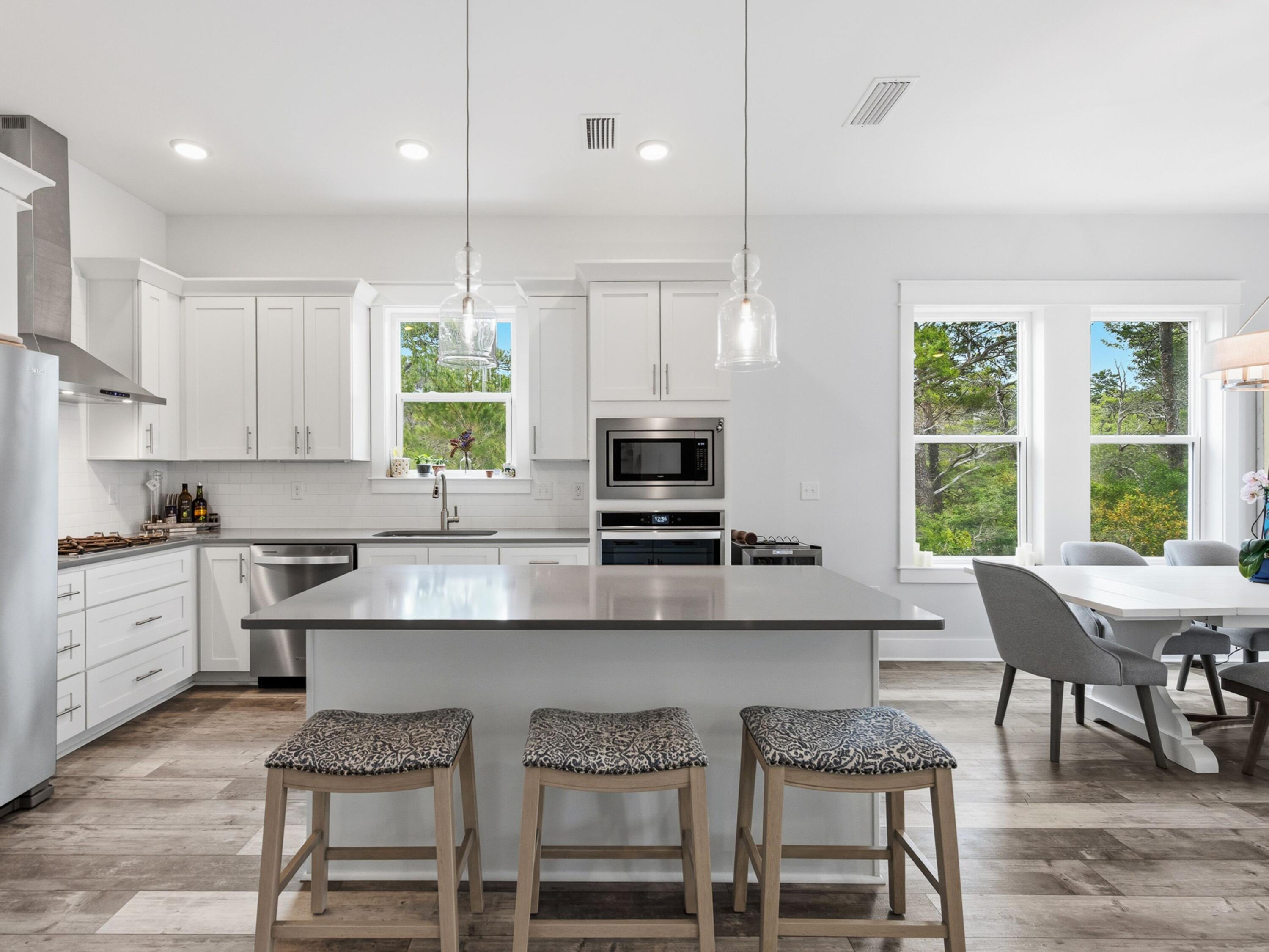 Set on a premium homesite in the northeast corner of Serenity at Dune Allen, this beautifully maintained three-story residence offers a rare sense of privacy along 30A's west end. Green space borders the home to the north and east, creating a quiet natural backdrop that distinguishes the property from others in the community while placing the beach within easy walking distance.

Never rented and presented in like-new condition, this four-bedroom, four-and-a-half-bath home is designed with comfort, flexibility and effortless coastal living in mind. Over 1100 sq. ft. in exterior porch spaces plus extended parking provides a valuable advantage for owners and guests, while the versatile layout supports use as a primary residence, second home or future rental investment. The main living level is bright and inviting, with raised ceilings, abundant natural light and an open-concept design that connects the chef's kitchen, dining and gathering spaces with ease. Modern finishes lend a polished coastal feel, while multiple porches across all three levels invite quiet mornings, afternoon breezes and relaxed evenings outdoors.

All four bedrooms feature ensuite baths and private porch access, offering a thoughtful level of comfort for family and guests. The second and third levels each include two spacious bedroom suites along with flex nooks suited for a home office, reading area or secondary lounge space. A screened rear patio expands the outdoor living experience, providing another shaded place to enjoy the home's peaceful setting.

With a community pool, beach access nearby and one of the more desirable homesites in Serenity at Dune Allen, this home pairs convenience with privacy in a location made for the 30A lifestyle.