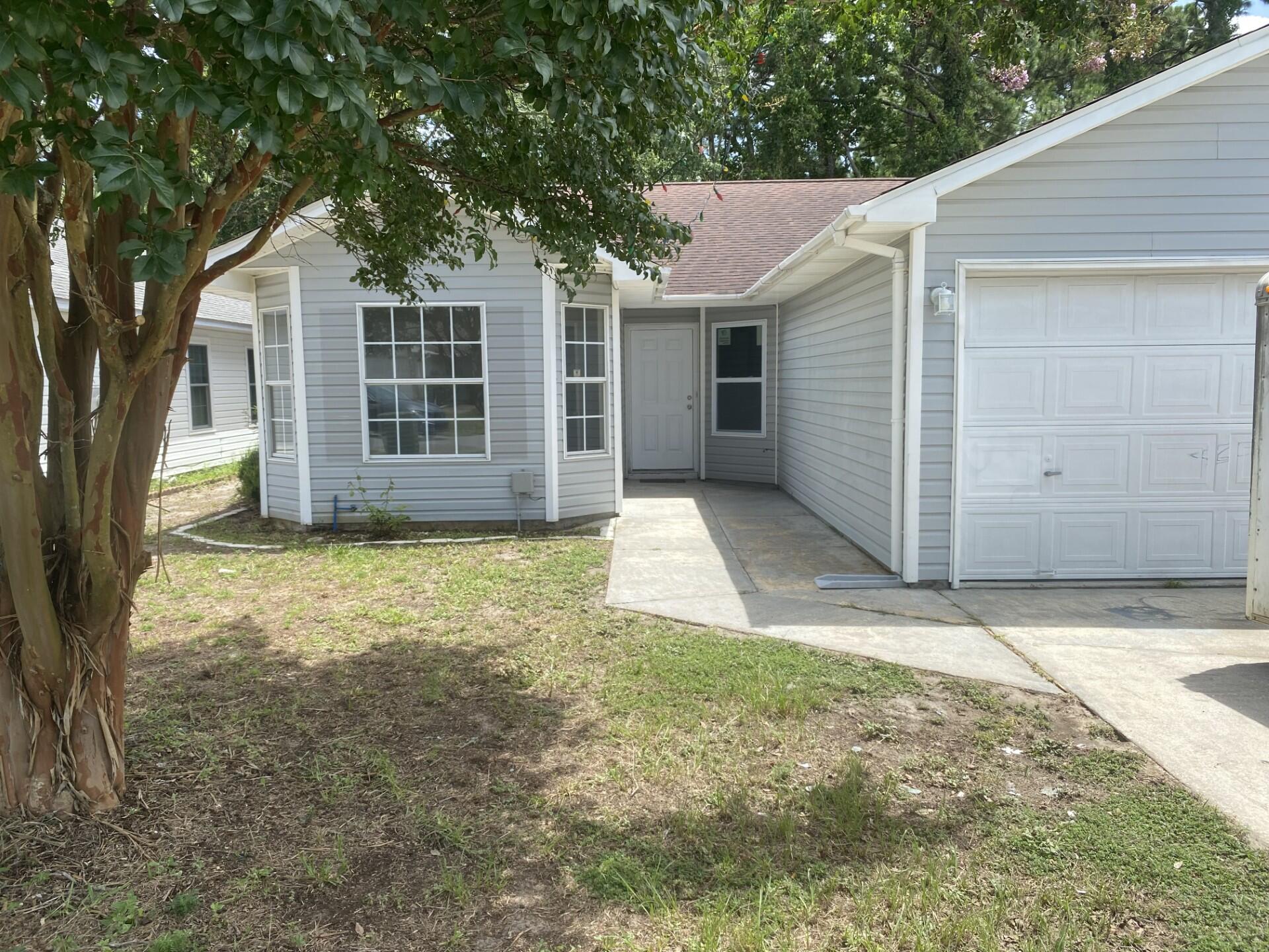 Your opportunity to scoop this FOUR bedroom one story home with 2 car garage, new windows (July '26 - with last couple on order), and all new flooring (July '26) except tile in wet areas! You also benefit from the complete interior having been newly painted, including removing popcorn  and now has flat finish in July '26!! The sliding glass backdoor to the yard is new in July '26, too, and the hot water heater was new in '24! With 4 bedrooms, you can have your special office / hobby room or give the kids some personal space.  The floorplan provides a great room that is open to the dining area and kitchen!  The 2 car garage has a work bench for your tinkering improver!  This little known location is a very private enclave that is in the heart of Mary Esther, close to shopping and restaurants! Schools are top notch in Okaloosa County with most getting A's! You are never far from the white sandy beaches of the Emerald Coast, so make your appointment to see this fabulous home, and make your offer!  Cheers!