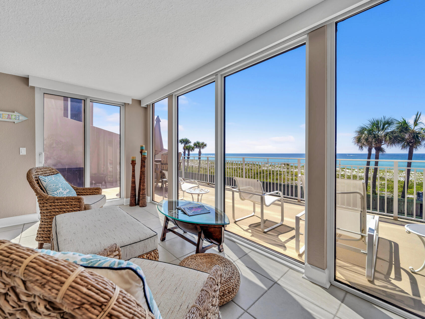 Breathtaking views from every room. Directly on the beach this condo comes with a double size patio for lounging or entertaining & steps to the beach. Private garage parking. Two gulf front bedrooms, extended living area, tile floors, large master suite, stainless steel appliances, quartz countertops, new A/C unit,& electric sun shades. The master bath has a large shower, quartz countertops and plenty of closet space/storage. The guest bathroom has been remodeled w/ subway tile and marble floors. With over 240 ft of beachfront, this low density complex has one of the least crowded beaches along the Emerald Coast. This 24 unit building is located on Holiday Isle with amenities that include: swimming pool, tennis court and security gate.