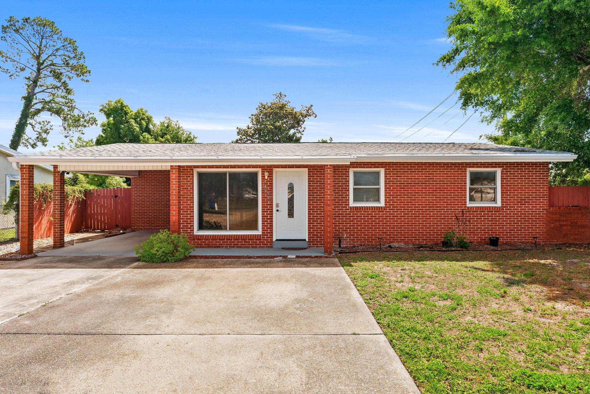 Welcome to 1900 Beck Ave., a beautifully maintained all-brick home perfectly positioned just minutes from the heart of Historic St. Andrews which is one of Panama City's most sought-after waterfront communities known for its vibrant coastal charm, local restaurants, marinas, boutique shopping, waterfront parks, farmers markets, and year-round community events. 

Situated on a spacious corner lot, this 3-bedroom, 2-bathroom residence combines comfort, functionality, and convenience. Step inside to discover a massive 23x25 living room highlighted by luxury vinyl plank waterproof flooring, creating the perfect space for entertaining or relaxing. The updated kitchen features stainless steel appliances, elegant white cabinetry, granite countertops, and a custom backsplash, blending style and practicality seamlessly.

Additional upgrades include all new PEX plumbing throughout, a reliable ADT security system, and the added benefit of being located in Flood Zone X, where flood insurance is not typically required. A new roof was installed in 2018, and the home currently carries an affordable homeowner's insurance premium available upon request. Outside, the oversized double driveway and covered carport provide ample parking for multiple vehicles, while the large, fenced backyard with convenient access gates offers ideal space for boat or RV storage, perfect for those wanting to take advantage of the nearby bay, marinas, and waterfront lifestyle. Enjoy outdoor gatherings on the spacious covered patio or unwind in the private backyard complete with a farmhouse-style storage shed. 

Living near Historic St. Andrews offers a unique coastal lifestyle where golf cart rides to dinner, sunset walks along the bay, live music, boating adventures, and weekends at the marina become part of everyday life. Whether you are enjoying fresh seafood at locally loved restaurants, exploring nearby coffee shops and boutiques, or taking advantage of the area's shopping, dining, entertainment, and commercial conveniences, this location places you near the very best of Panama City. With exceptional accessibility and strong appeal for both homeowners and investors alike, this property presents an incredible opportunity for first-time buyers, long-term rental potential, or anyone looking to embrace the relaxed coastal lifestyle that makes St. Andrews such a desirable place to live. Schedule your private showing today!