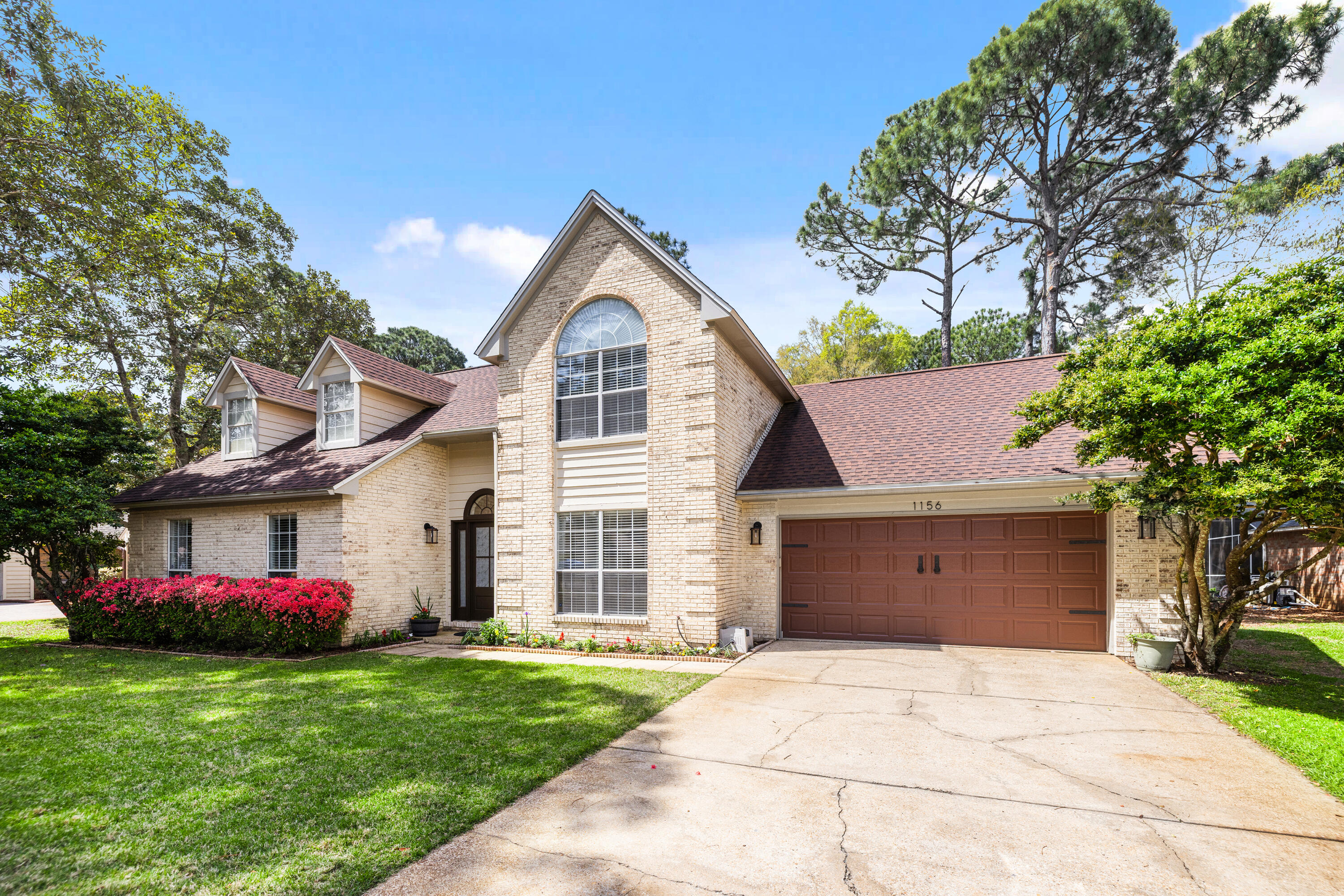 Beautifully updated home in Bluewater Bay with 4 bedrooms, 2.5 baths, 3,022 sq ft, vaulted ceilings, skylights, French doors, built-ins, and a spacious sun-filled living area. The kitchen features granite countertops, white cabinets, subway tile, and generous prep space. Updated bathrooms, living room, and Florida room give this home a move-in-ready feel. ASSUMABLE 4.0% VA FIXED LOAN may be available to a qualified buyer, subject to lender approval. Primary bath offers a walk-in glass shower, marble double vanity, extra closet space, and chandelier. Fenced backyard, open deck, mature landscaping, two-car garage, golf setting, trails, marina, pickleball, tennis, pool, restaurants, and Niceville schools.