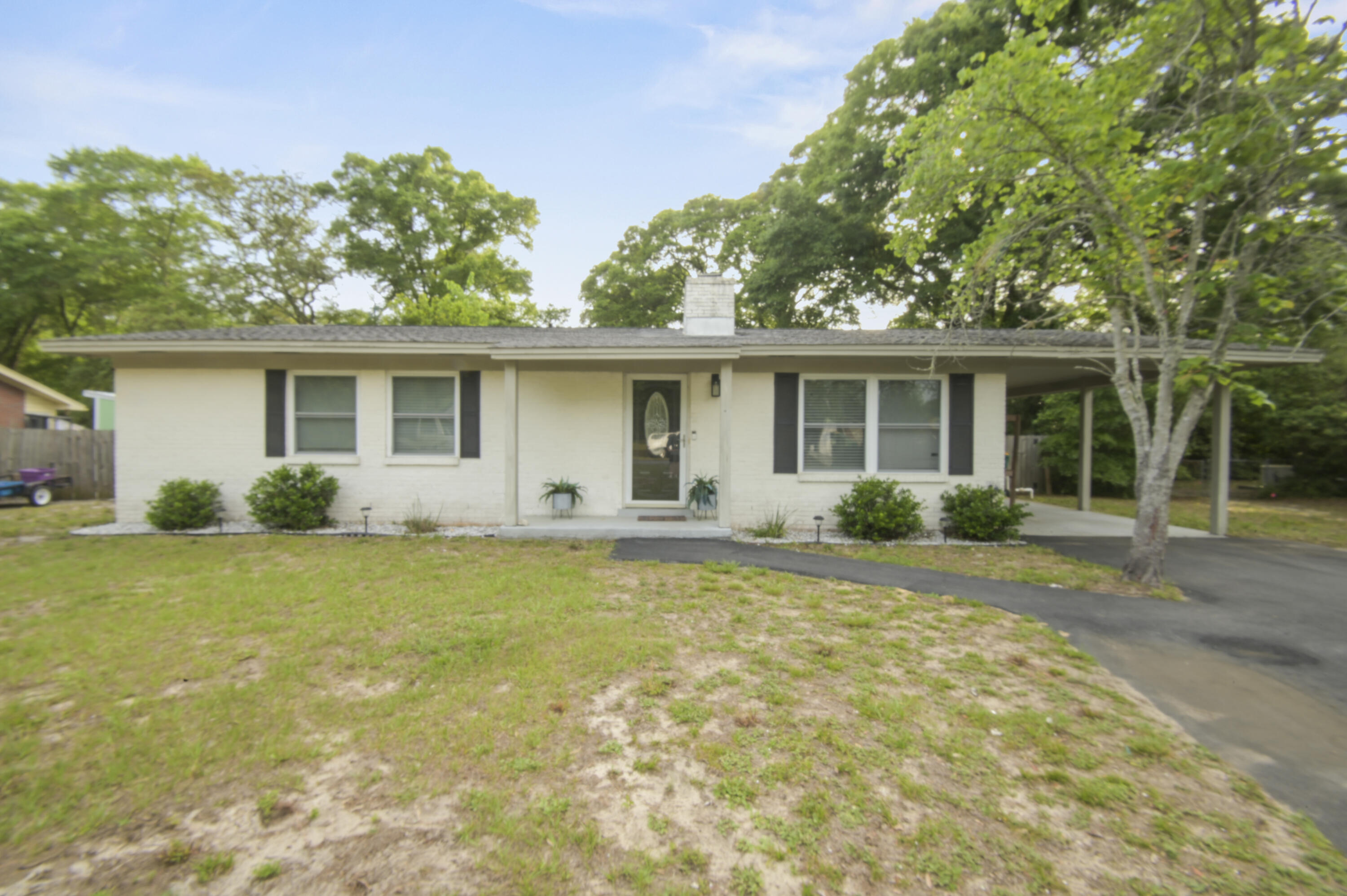 This beautifully updated brick 3-bedroom, 2-bath home in The heart of Fort Walton Beach checks all the boxes. The open floor plan makes the space feel larger than it is, with ceramic tile running through all main living areas and carpet in the bedrooms. The kitchen has been tastefully modernized with granite countertops, subway tile backsplash, and stainless steel appliances and modern units.  The sun-filled family room is the heart of the home, anchored by a wood-burning fireplace and opening directly to a large, fenced backyard with a generous patio and pergola -- ideal for weekend cookouts or winding down in the evenings. The master suite features a tiled master shower and updated vanity give the primary bath a clean, finished look. Updates over the past few years include the AC unit, water heater, paint, lighting, and flooring, so the big-ticket items are already handled. The community also features a private boat launch -- a standout perk for anyone who enjoys life on the water. Located in Colony Estates, you're just minutes from schools, shopping, and restaurants, with easy access to Hurlburt Field, Eglin AFB, and the beaches of Okaloosa Island. This one is worth a look -- schedule your tour today!