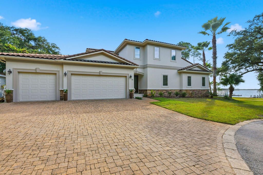 A rare opportunity to own a premier Sound-front residence in one of Mary Esther's most private and desirable locations.
Perfectly positioned at the end of a quiet cul-de-sac just east of Mary Esther Blvd, this deep-water property offers exceptional luxury living with panoramic views of the Santa Rosa Sound and the Gulf. The main level showcases 10' ceilings, a guest suite with full bath, and expansive living, dining, and kitchen spaces designed to maximize natural light and water views. Upstairs, 9' ceilings, a spacious master retreat, and a convenient laundry room create an ideal layout for comfort and privacy. Every bedroom features its own private full bath and direct views of the Sound, with two oversized balcony doors leading to a serene outdoor sitting area—perfect for sunrise coffee or sunset relaxation.

Situated on over half an acre, the home sits elevated and set back from rising waters, offering both peace of mind and stunning vantage points. The large veranda overlooking the backyard is ideal for entertaining, complete with an outdoor gas fireplace for cozy evenings. The luxurious Master Suite includes a wet bar, gas fireplace, and breathtaking dual views of the Sound and Gulf, along with an expansive 11' × 12' walk-in closet. The kitchen boasts a massive center island designed for gathering, entertaining, and everyday enjoyment, while a large room just off the kitchen providing additional flexible living space to use as YOU desire.

Additional features include a heated and cooled workshop with a sink inside the garage... just the place for hobbies or projects. From the private dock, enjoy fishing, sunning, boating, or watching spectacular fireworks displays from Fort Walton Beach, Hurlburt Field, and Navarre.

This remarkable home is a true slice of paradise on the Emerald Coast and an exceptional chance to own unmatched Sound-front luxury in Mary Esther.