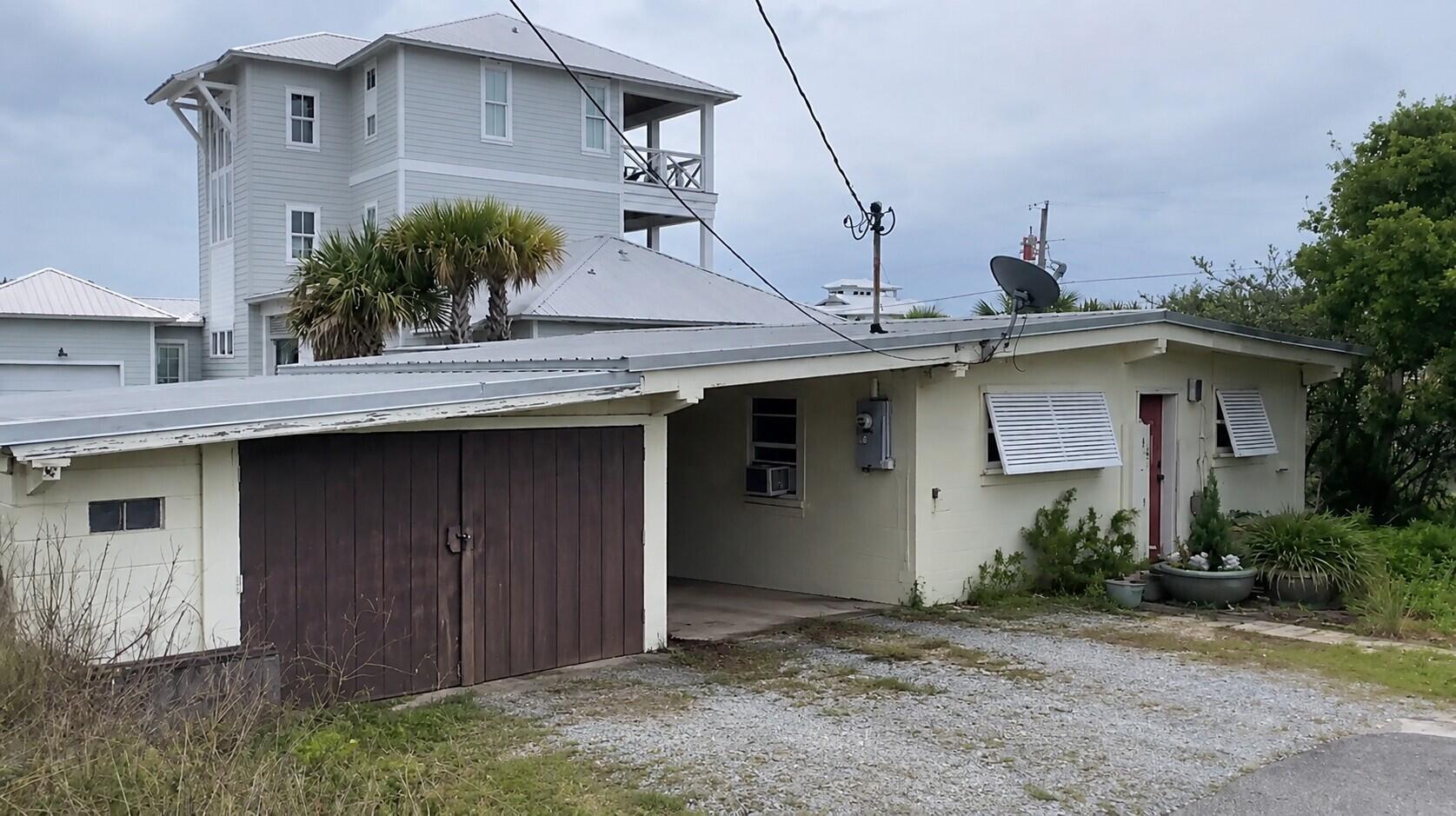 This is liveable, but essentially a teardown. The home is surrounded by multi-million dollar & multi-level homes. This lot/land has gulf views and an oversized lot. Not in a flood plain and 1.5 blocks from 30A. A dream spot for a dream home!